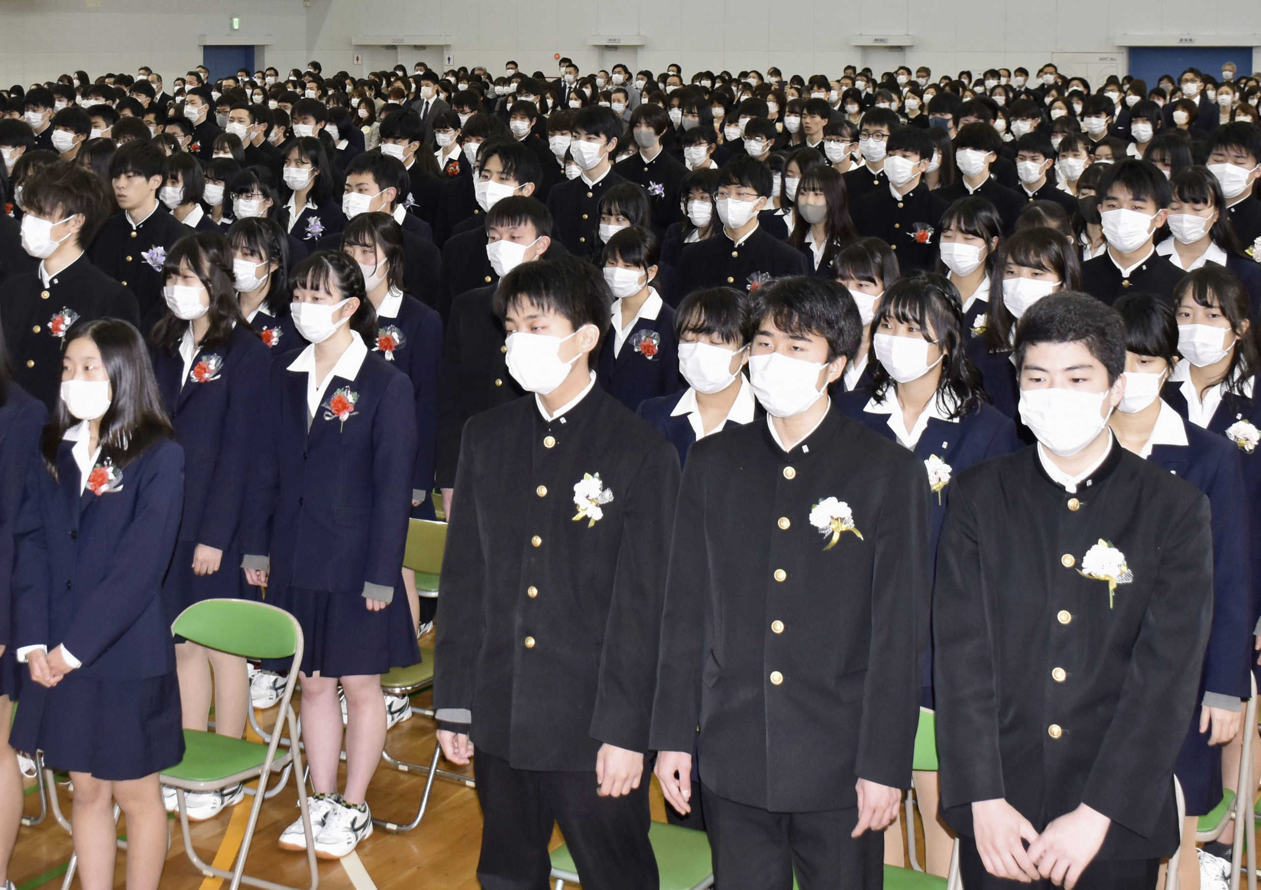 Students wear masks amid concerns about the new coronavirus during their graduation ceremony at Koyo Senior High School in Nagoya, central Japan, March 2, 2020, in this photo taken by Kyodo.  Mandatory credit Kyodo