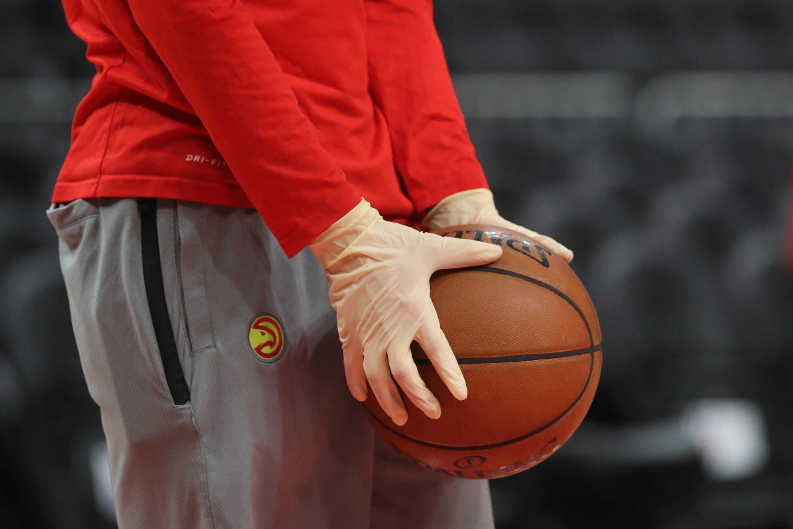 Mar 11, 2020; Atlanta, Georgia, USA; An Atlanta Hawks ball boy wear rubber gloves during practice before a game between the New York Knicks and the Hawks at State Farm Arena. Mandatory Credit: Jason Getz-USA TODAY Sports