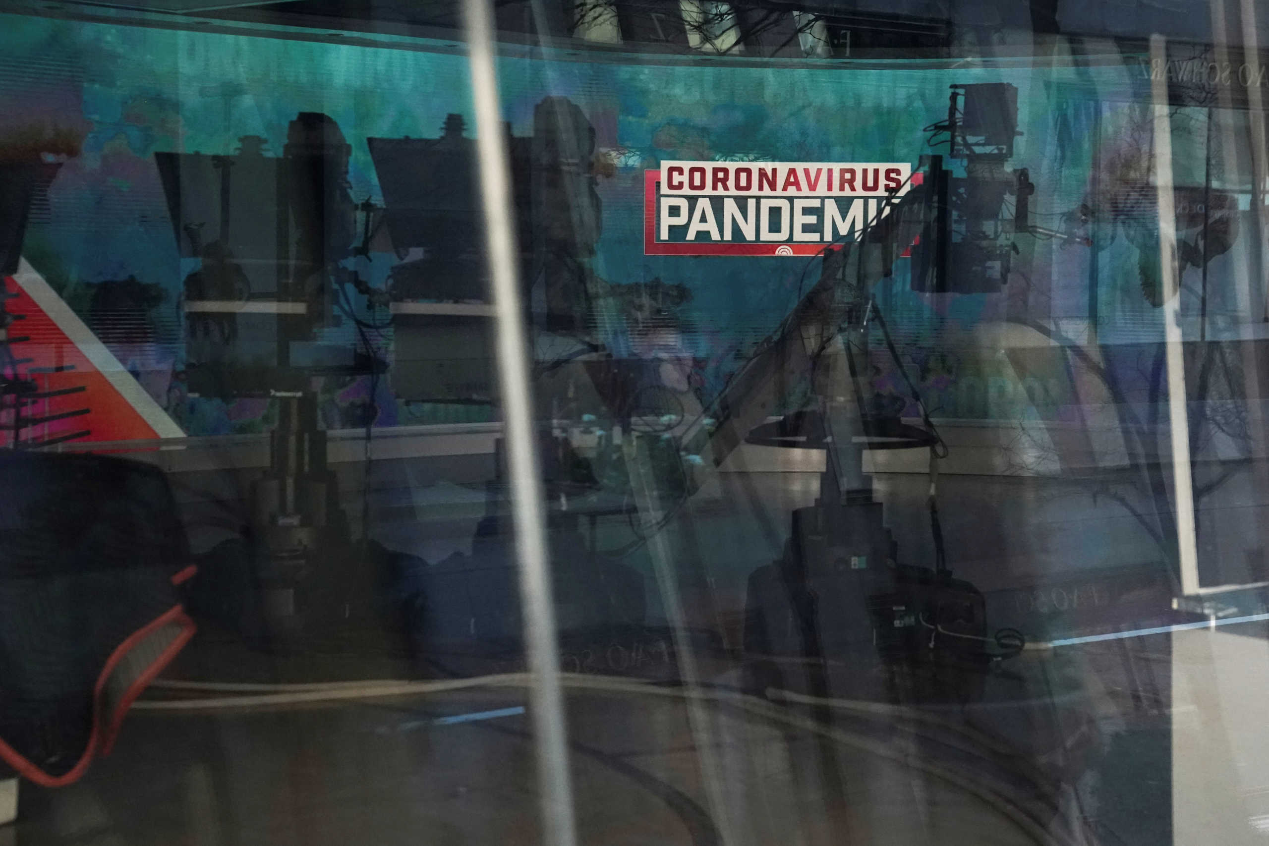 A "Coronavirus Pandemic" sign is pictured though a window at a closed NBC news studio following the outbreak of coronavirus disease (COVID-19), in the Manhattan borough of New York City, New York, U.S., March 24, 2020. REUTERS