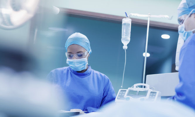 Doctors performing surgery in hospital operating room