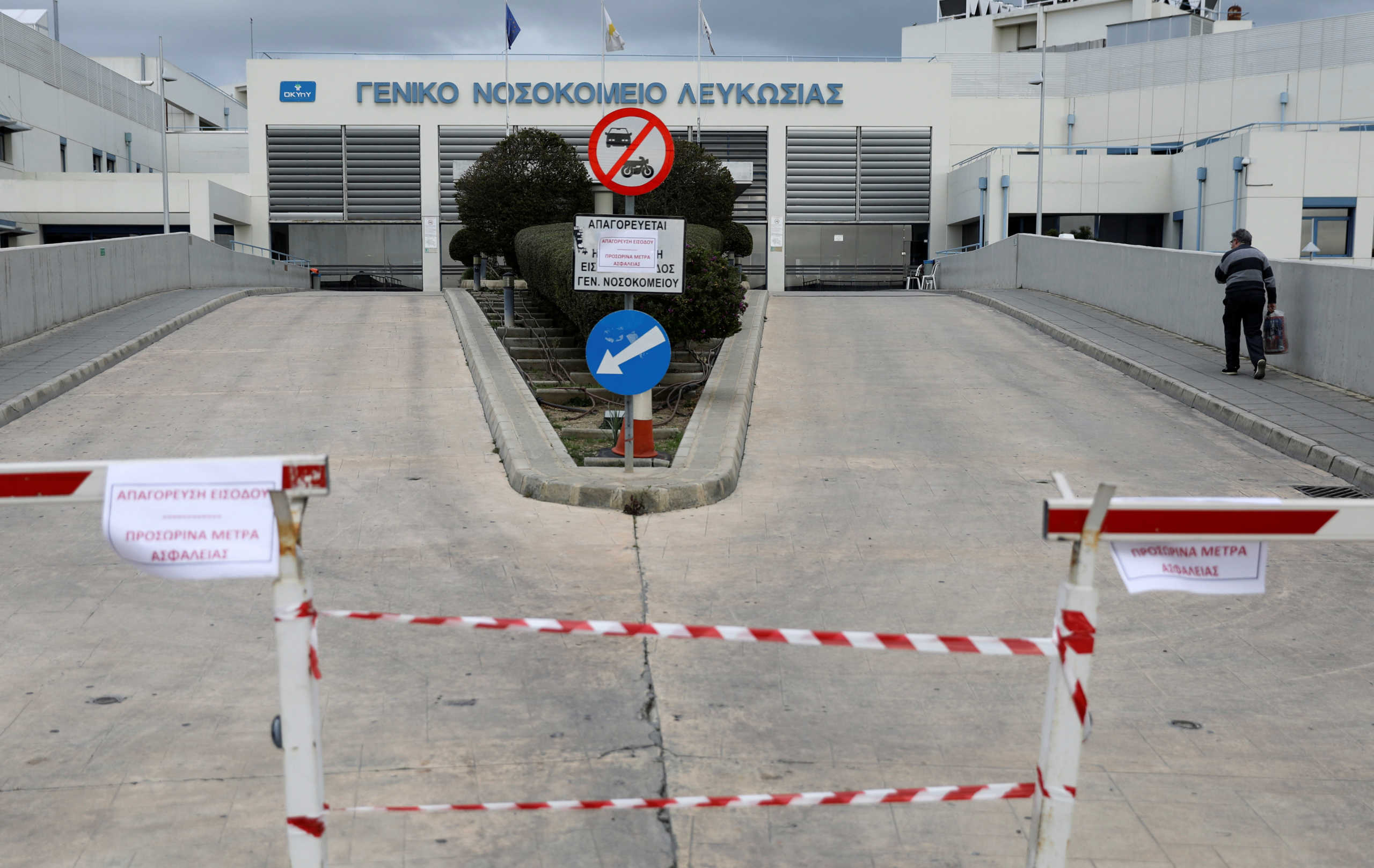 A man walks outside Nicosia General hospital, Cyprus's largest medical facility that suspended admissions on Tuesday after a heart surgeon tested positive for coronavirus, in Nicosia, Cyprus March 10, 2020. REUTERS