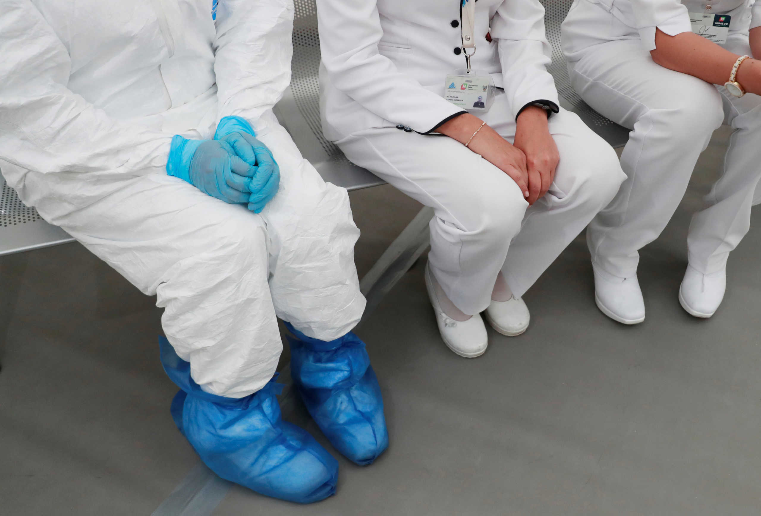 A medical specialist wearing protective gear sitting next to two nurses inside the new immediate response mobile hospital with 50 intensive care beds against the outbreak of coronavirus disease (COVID-19) in Pachuca, Hidalgo, Mexico, March 19, 2020. Picture taken March 18, 2020. REUTERS