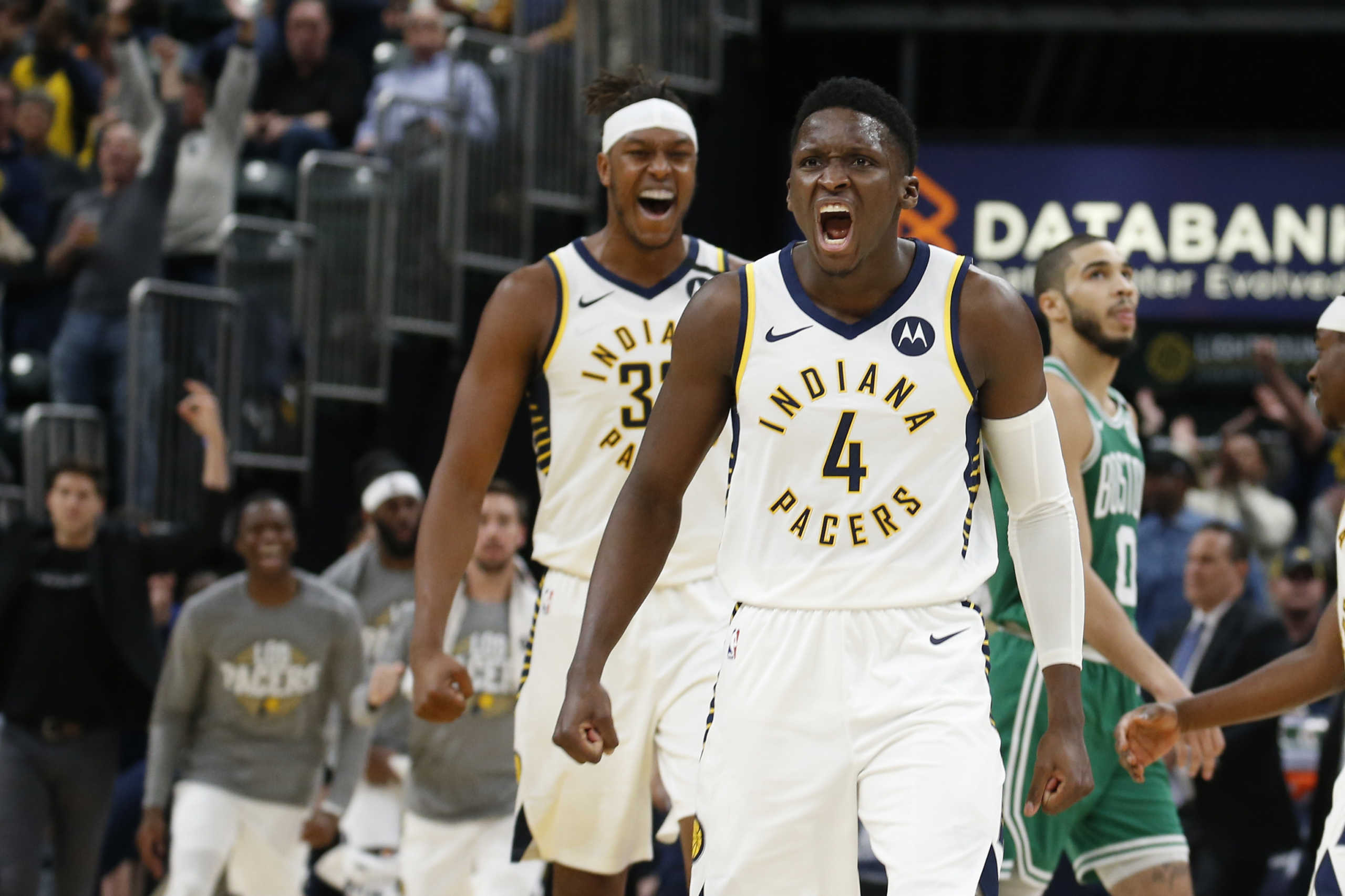 Mar 10, 2020; Indianapolis, Indiana, USA; Indiana Pacers guard Victor Oladipo (4) and center Myles Turner (33) react after a three point basket by Oladipo against the Boston Celtics during the fourth quarter at Bankers Life Fieldhouse. Mandatory Credit: Brian Spurlock-USA TODAY Sports