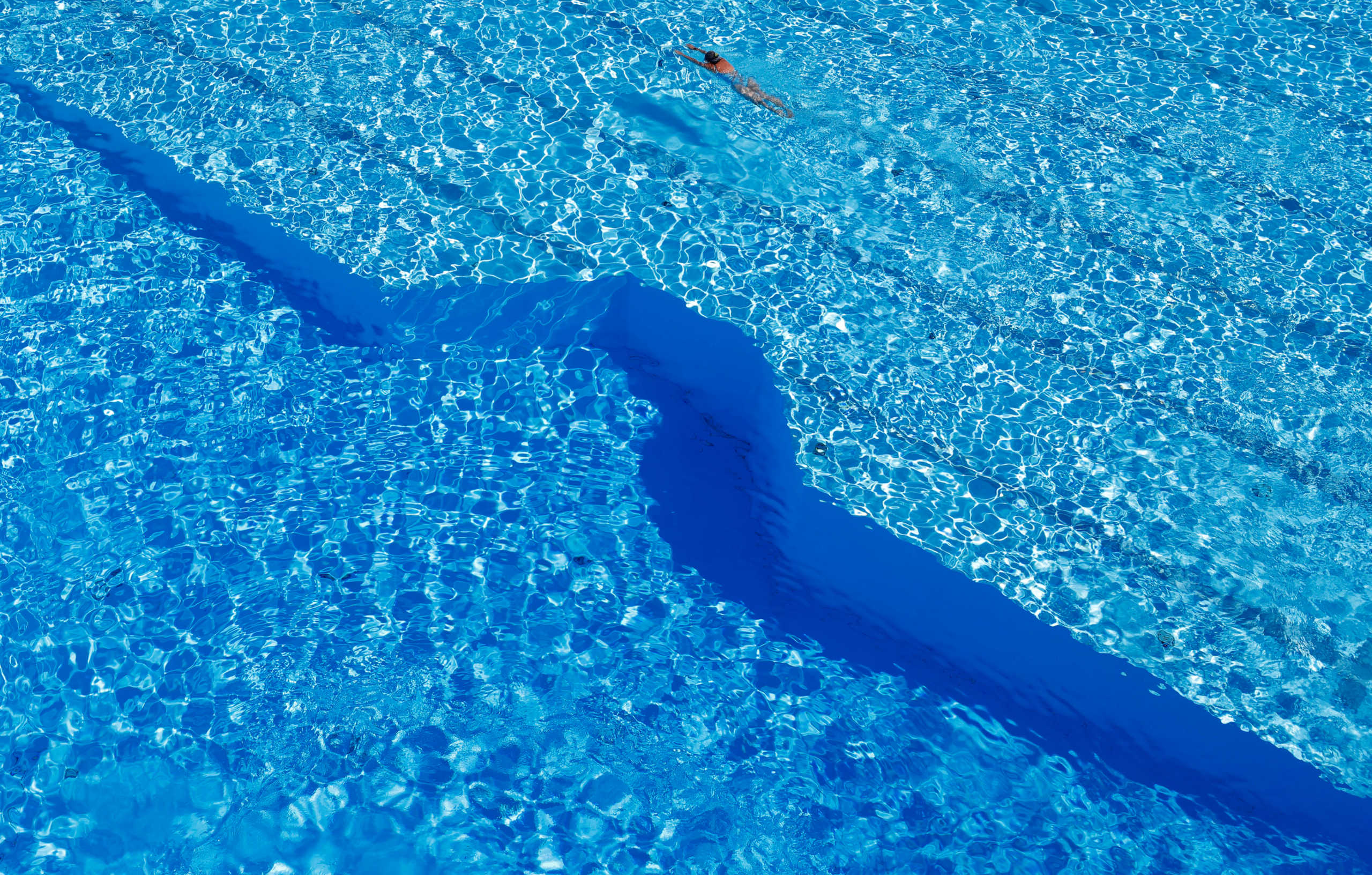 A woman swims in a public pool as temperatures reach new record highs in Hanau, near Frankfurt, Germany, July 24, 2019.   REUTERS
