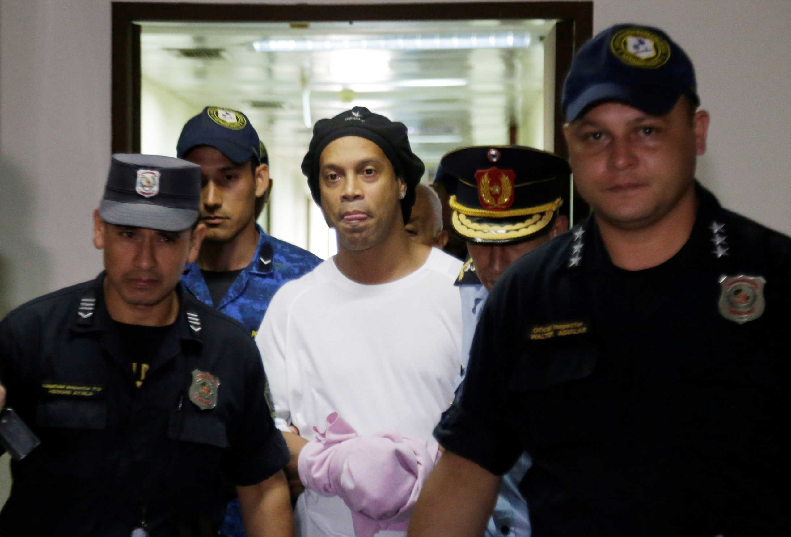Judge rules Ronaldinho must remain in Paraguayan jail - Paraguayan Supreme Court, Asuncion, Paraguay - March 7, 2020? Ronaldinho handcuffed and escorted by police at the Supreme Court of Paraguay?REUTERS