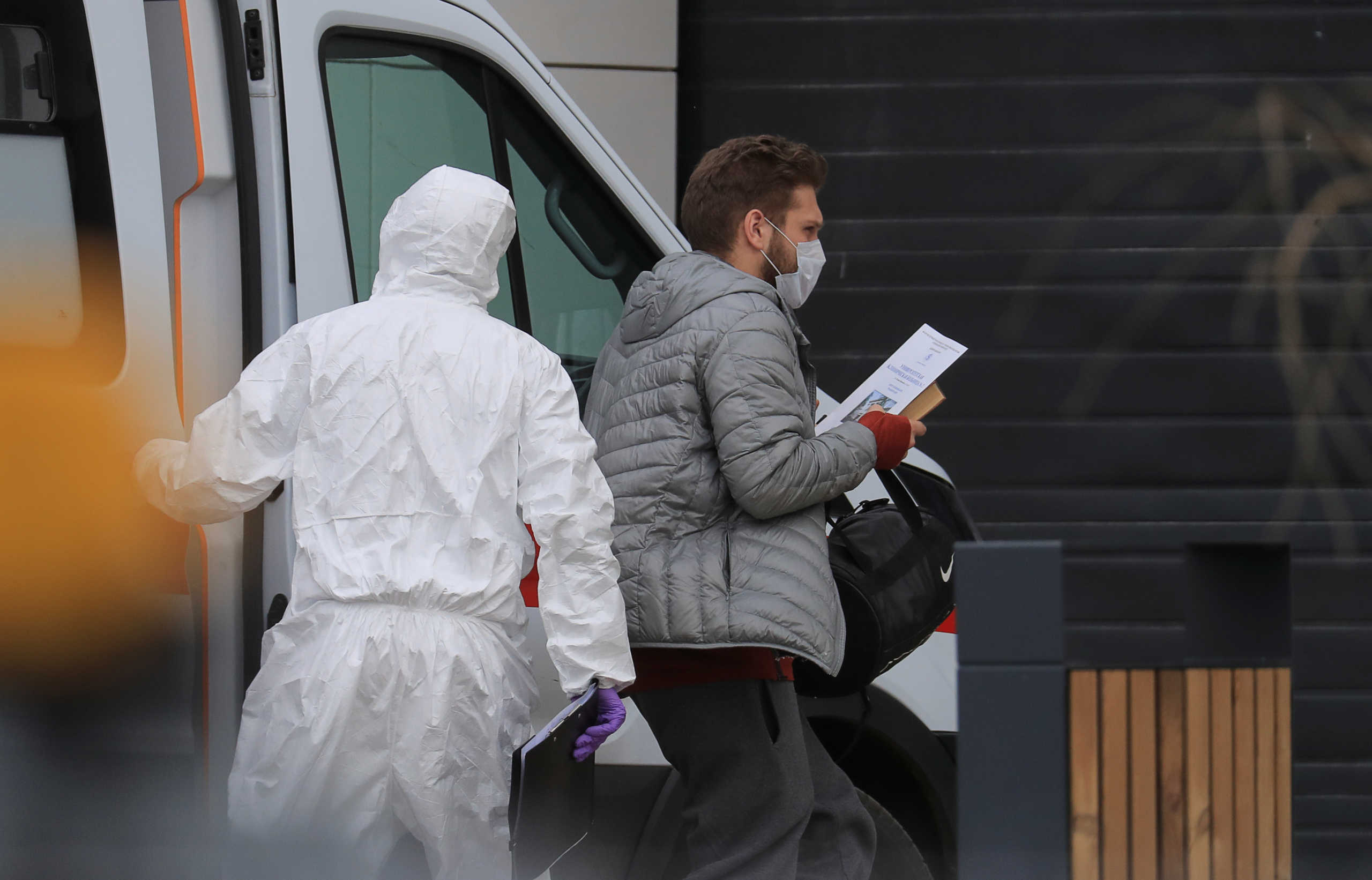 A man wearing a protective mask gets out of an ambulance upon the arrival at a hospital for patients infected with coronavirus disease (COVID-19) on the outskirts of Moscow, Russia March 19, 2020. REUTERS