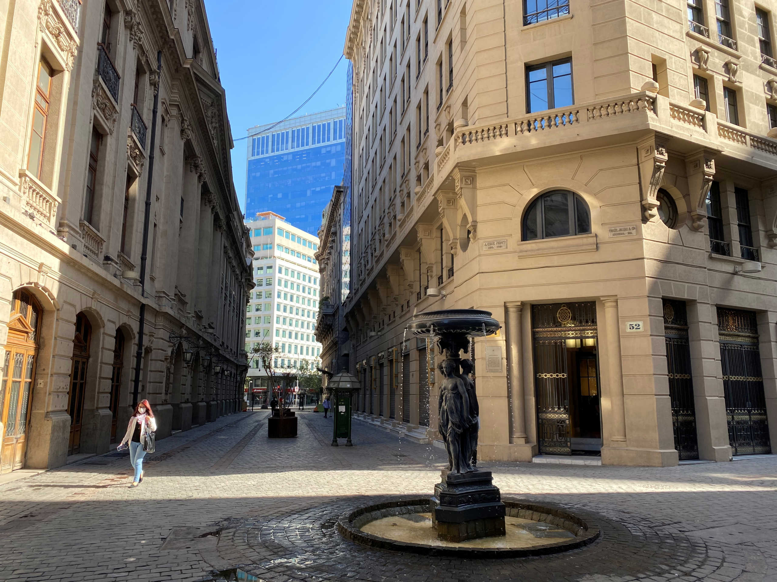 A woman walks past Santiago's stock exchange at an empty financial area, following the outbreak of the coronavirus disease (COVID-19), in Santiago, Chile March 25, 2020. REUTERS
