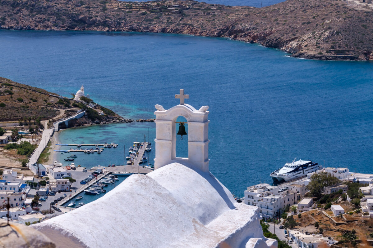 Breathtaking panoramic view of the port of Ios Greece from the rooftop of a whitewashed orthodox