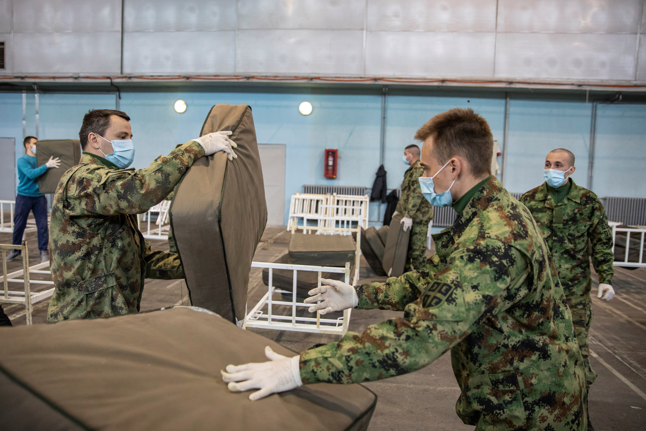 Serbian military and volunteers set up beds inside the Novi Sad Fair to accommodate people who suffer mild symptoms of coronavirus disease (COVID-19) in Novi Sad, Serbia, March 27, 2020. REUTERS