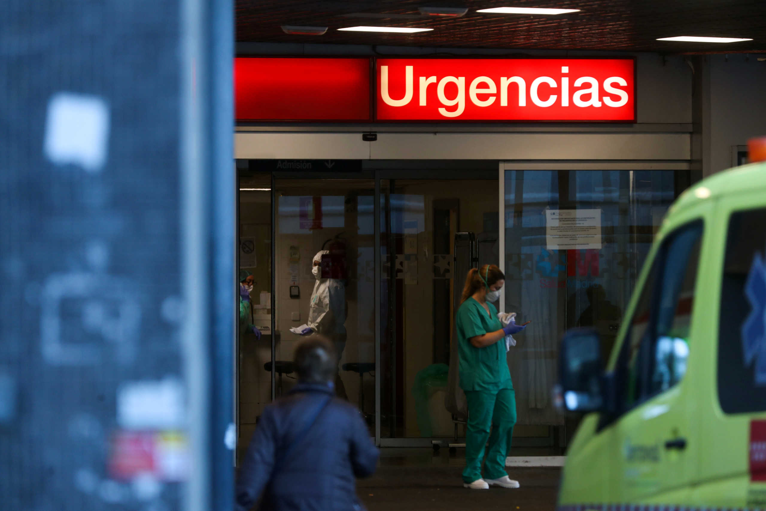 Healthcare workers are pictured at the entrance of the emergency unit at La Paz hospital during the coronavirus disease (COVID-19) outbreak in Madrid, Spain March 23, 2020. REUTERS