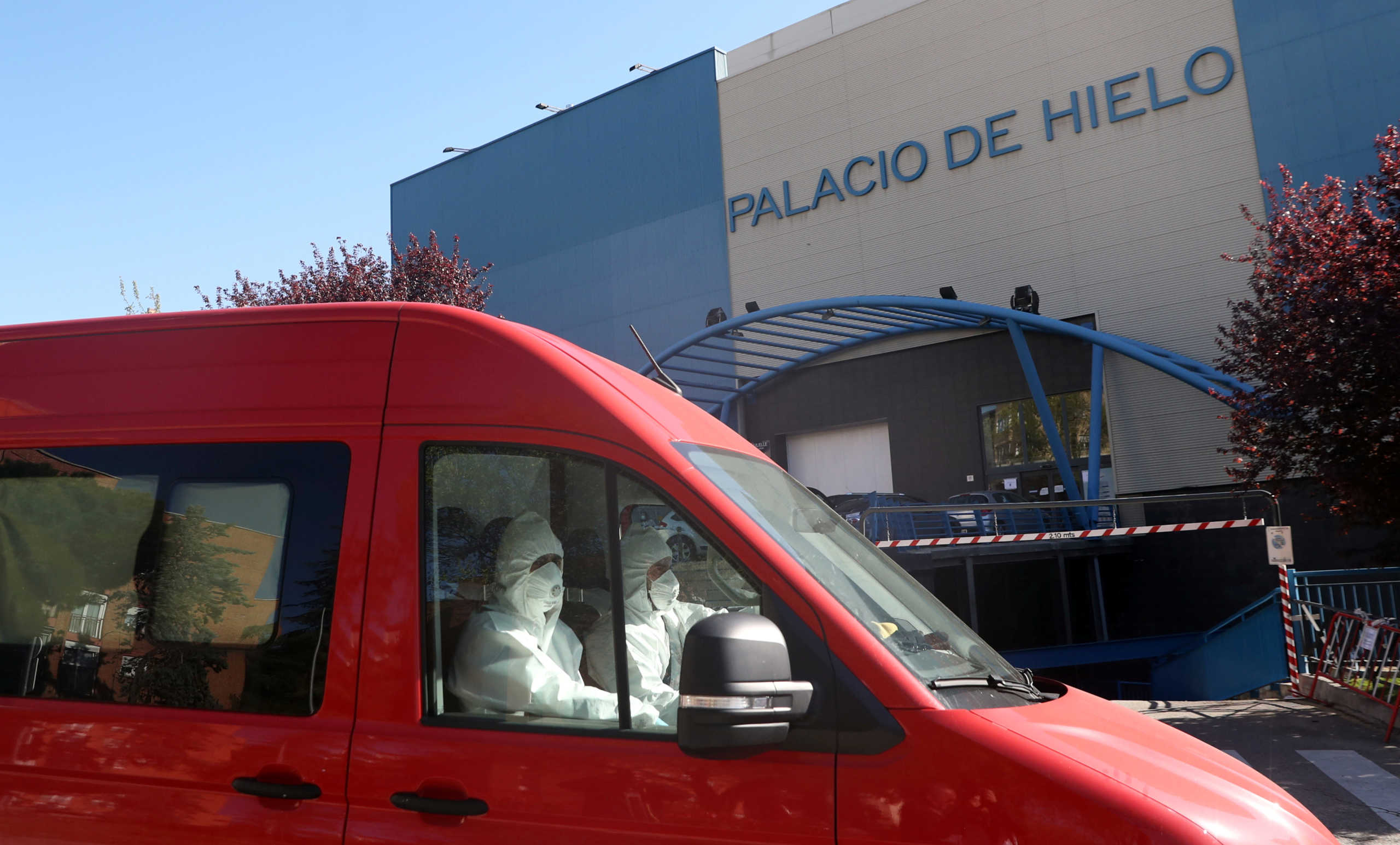 Members of the Spanish army wearing protective suits leave an ice rink, being used as a morgue, during the coronavirus disease (COVID-19) outbreak in Madrid, Spain, March 26, 2020. REUTERS