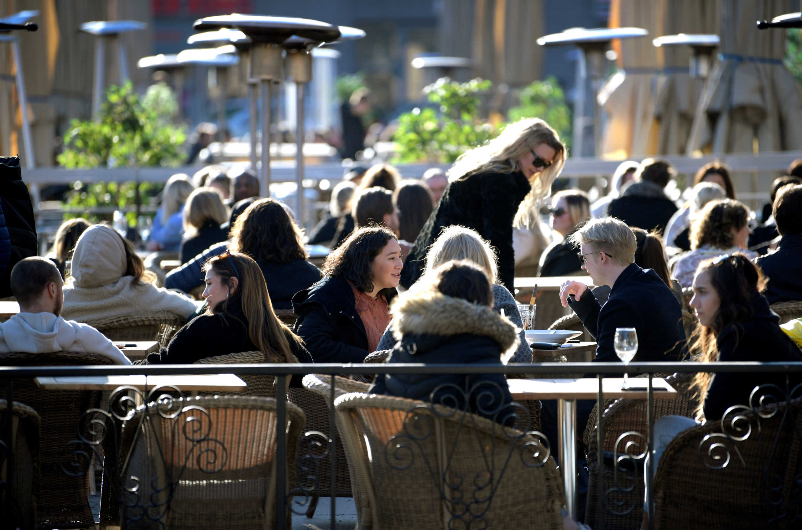 People enjoy the sun at an outdoor restaurant, despite the continuing spread of coronavirus disease (COVID-19), in Stockholm, Sweden March 26, 2020. TT News Agency