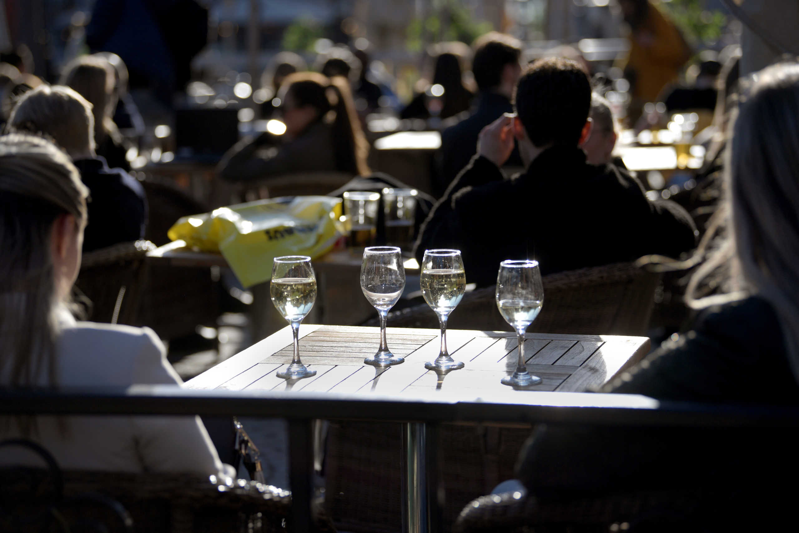 People enjoy the sun at an outdoor restaurant, despite the continuing spread of coronavirus disease (COVID-19), in Stockholm, Sweden March 26, 2020. TT News Agency