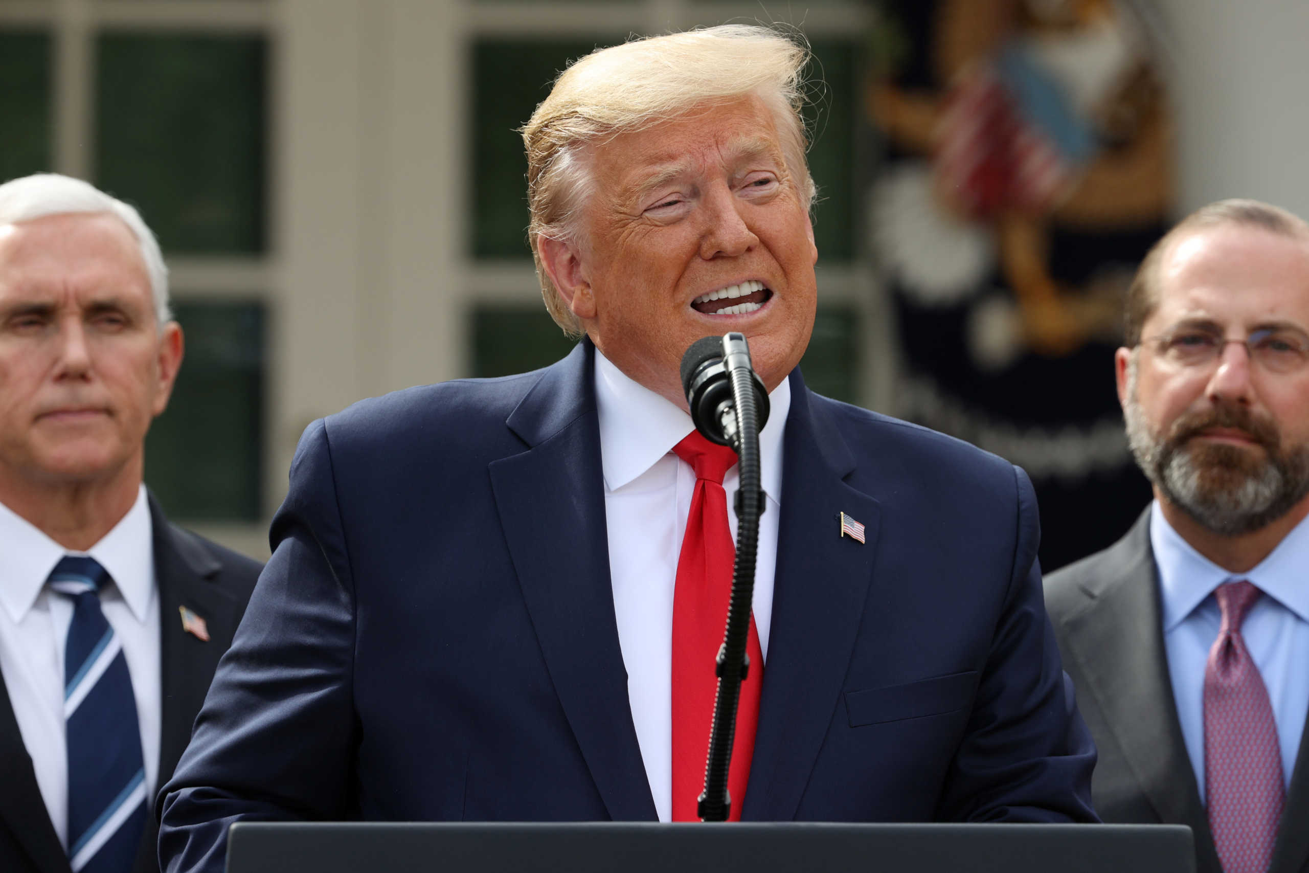 U.S. President Donald Trump is flanked by Vice President Mike Pence and Health and Human Services (HHS) Secretary Alex Azar during a news conference where the president declared the coronavirus pandemic a national emergency in the Rose Garden of the White House in Washington, U.S., March 13, 2020. REUTERS