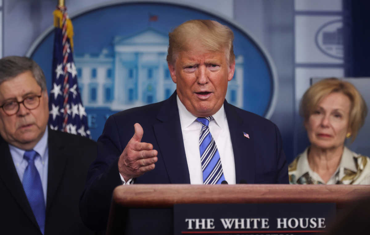 U.S. President Donald Trump addresses the coronavirus response daily briefing as Attorney General William Barr and Ambassador Debbie Birx, the White House coronavirus response coordinator, look on at the White House in Washington, U.S., March 23, 2020. REUTERS