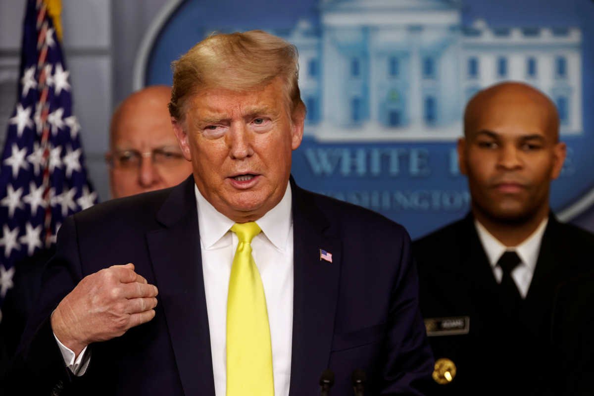 U.S. President Donald Trump speaks to the media as Surgeon General Jerome Adams (back R) looks on during the daily Coronavirus-related briefing at the White House in Washington, U.S. March 9, 2020.  REUTERS