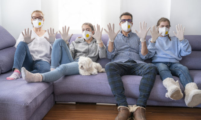Family at home sofa with mask and gloves in quarantine isolation against virus COVID-19 Coronavirus Corona Virus