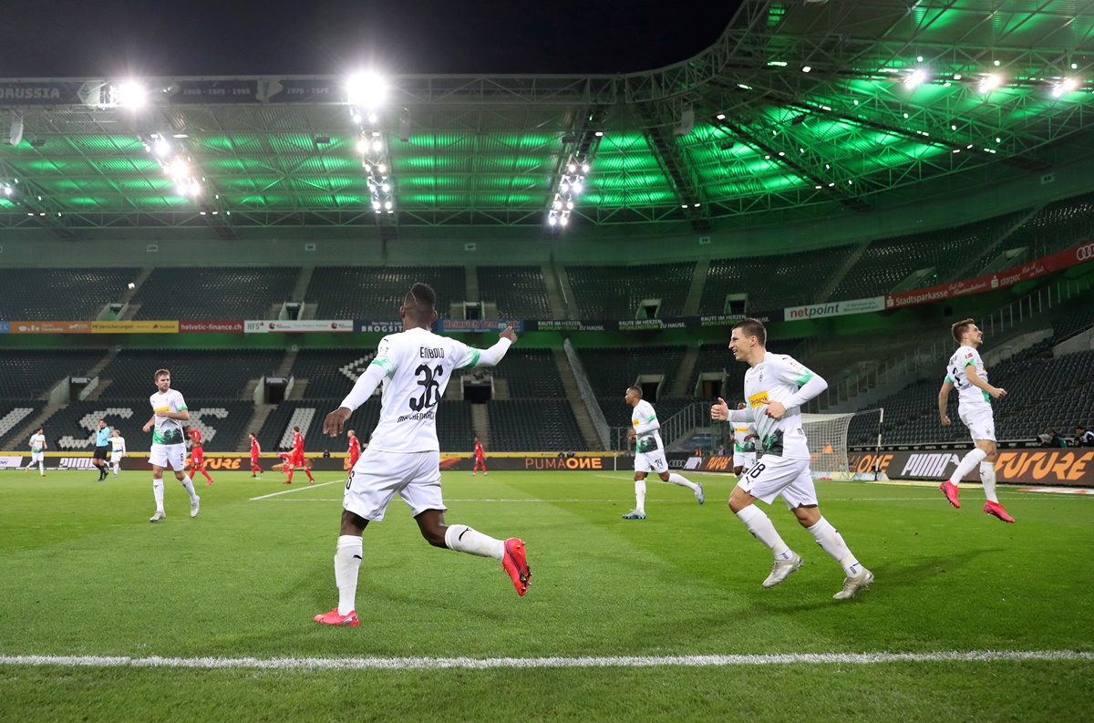 FILE PHOTO: Soccer Football - Bundesliga - Borussia Moenchengladbach v FC Cologne - Borussia-Park, Moenchengladbach, Germany - March 11, 2020  Borussia Moenchengladbach's Breel Embolo celebrates scoring their first goal with Stefan Lainer and teammates during the match being played behind closed doors while the number of coronavirus cases grow around the world  REUTERS