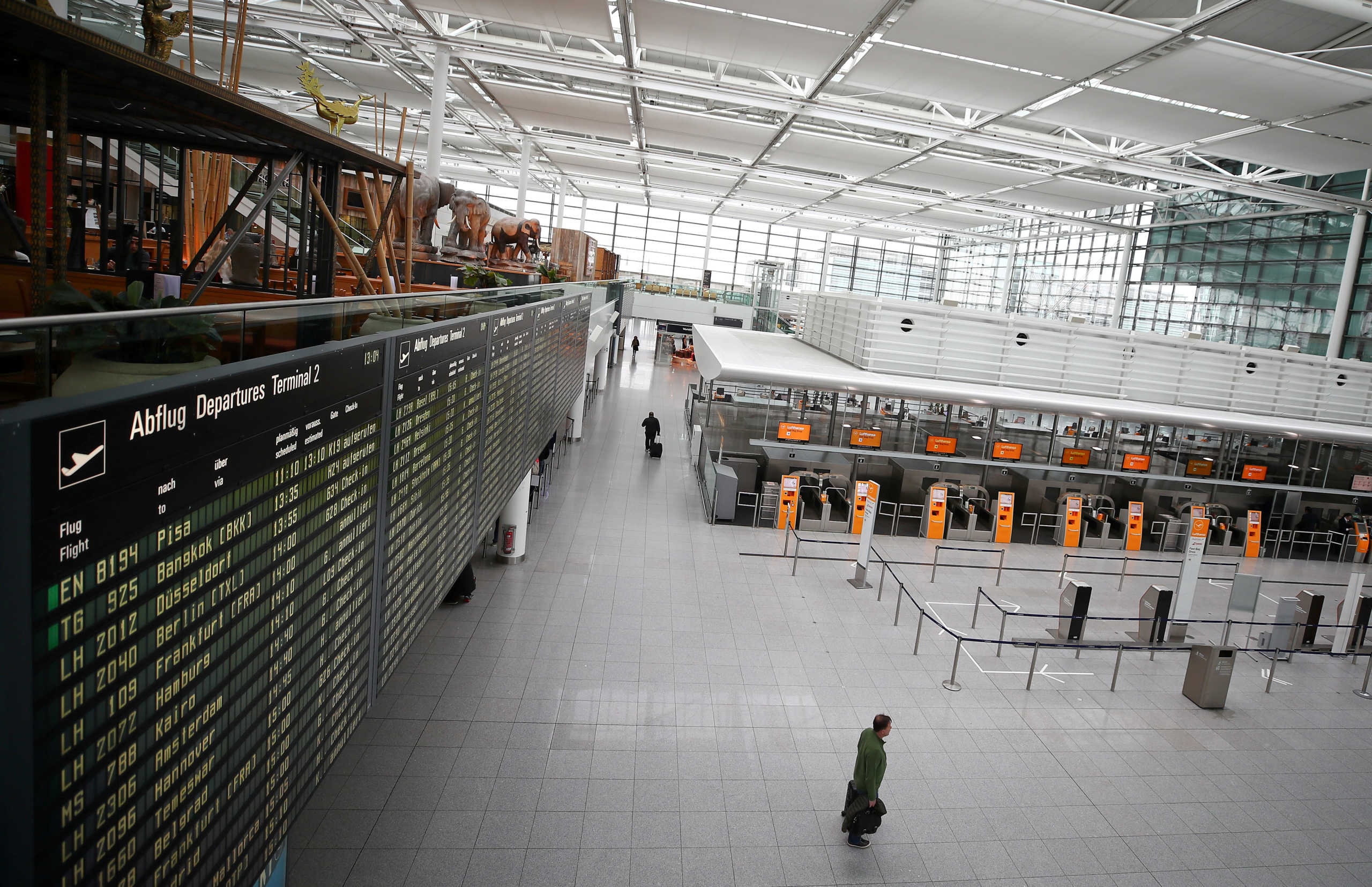 FILE PHOTO: Empty Lufthansa ticket counters are pictured at Munich's international airport, as the spread of the coronavirus disease (COVID-19) continues, in Germany, March 17, 2020. REUTERS
