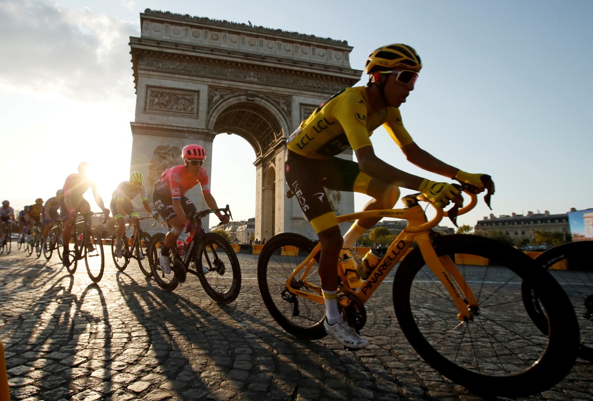 FILE PHOTO: Cycling - Tour de France - The 128-km Stage 21 from Rambouillet to Paris Champs-Elysees - July 28, 2019 - Team INEOS rider Egan Bernal of Colombia, wearing the overall leader's yellow jersey, in action in front of the Arc de Triomphe. REUTERS