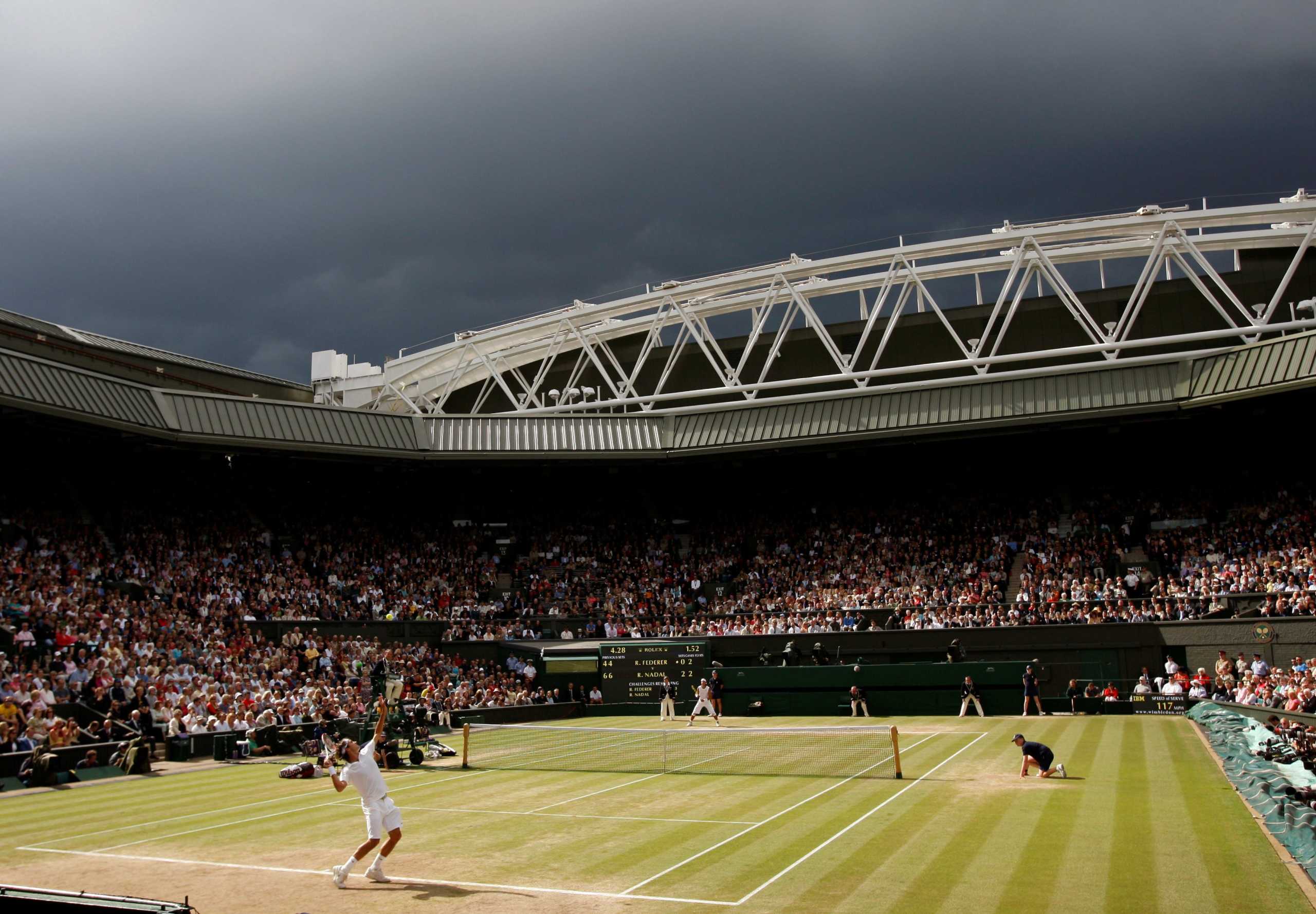 FILE PHOTO: Dark clouds drift over centre court during the finals match between Roger Federer of Switzerland and Rafael Nadal of Spain at the Wimbledon tennis championships in London July 6, 2008.   REUTERS