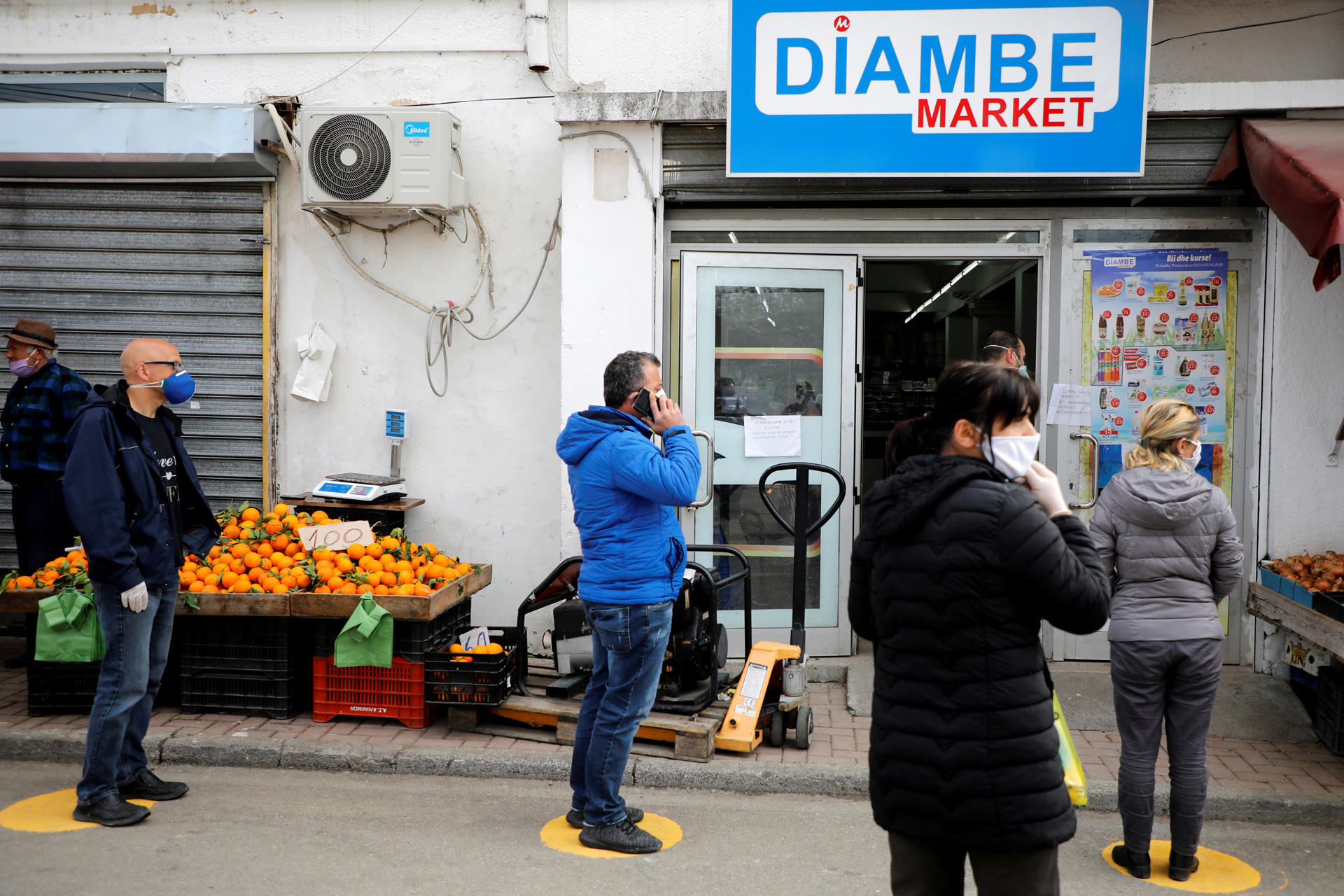 FILE PHOTO: Albanian people wait in line before entering a store, as Albanian authorities take measure to stop the spread of the coronavirus disease (COVID-19) in Tirana, Albania April 6, 2020. REUTERS