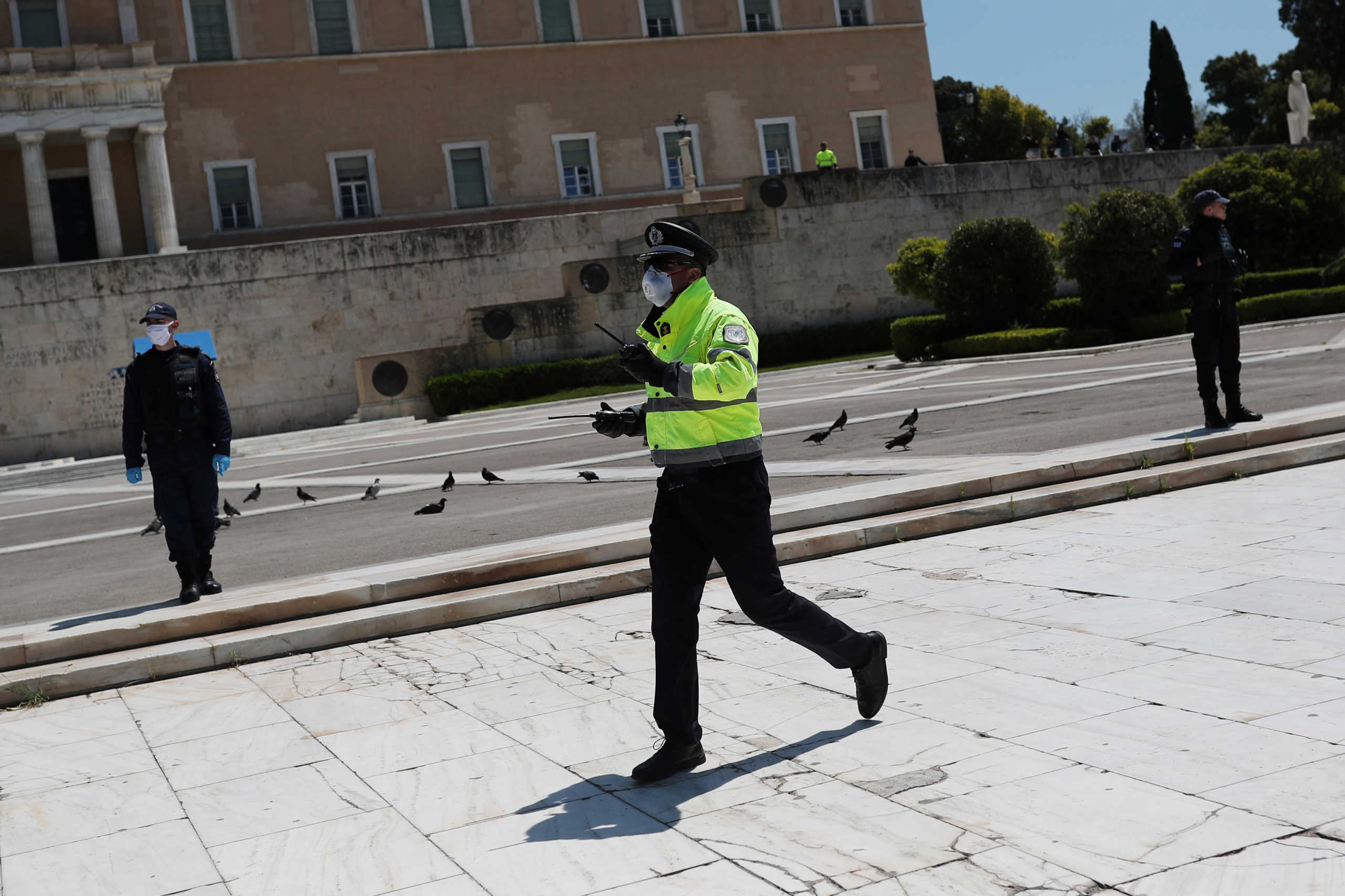 A Police officer wearing a protective face mask is seen as Greek teachers and students take part in a protest against government educational reforms, following the coronavirus disease (COVID-19) outbreak, in Athens, Greece, April 24, 2020. REUTERS