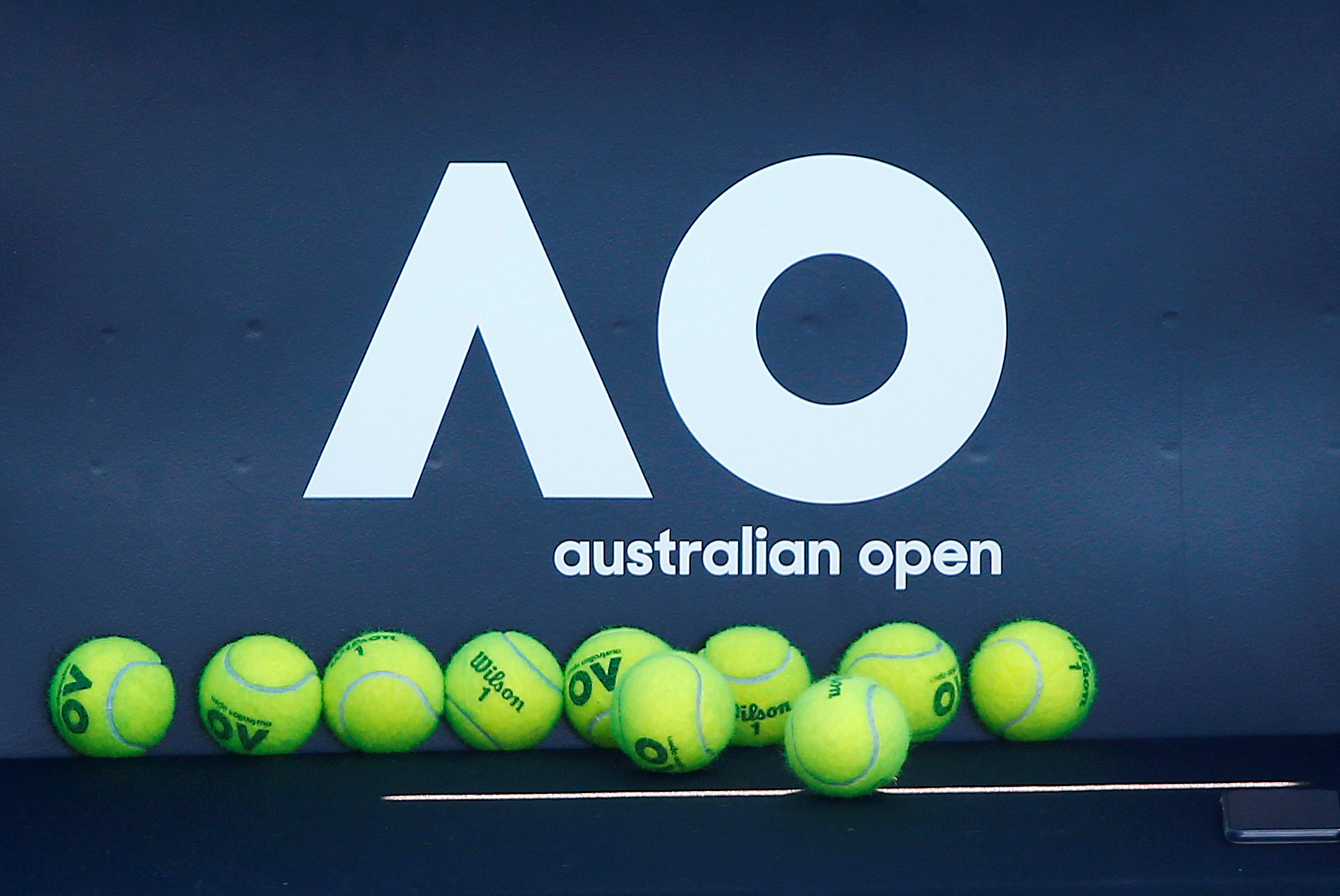 FILE PHOTO: Tennis - Australian Open - Melbourne, Australia, January 14, 2018. Tennis balls are pictured in front of the Australian Open logo before the tennis tournament. REUTERS