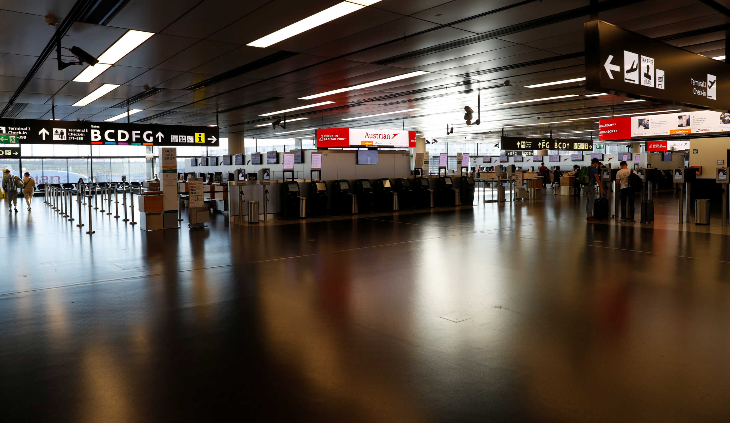 Empty Austrian Airlines check-in counters are seen during the spread of the coronavirus disease (COVID-19) at Vienna's airport in Schwechat, Austria March 18, 2020.   REUTERS