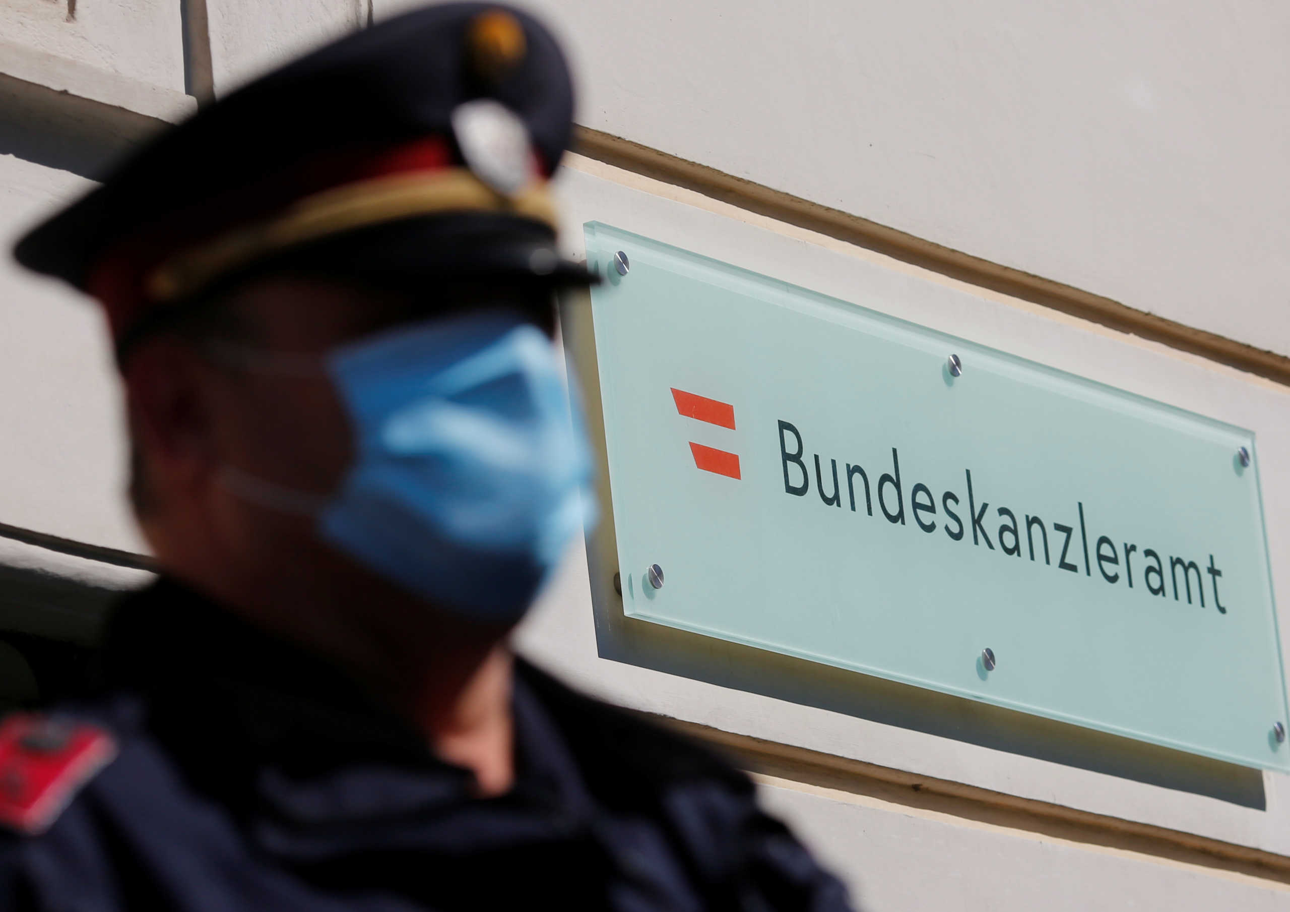 A police officer wearing a protective face mask stands in front of the Chancellery in Vienna, Austria April 6, 2020.   REUTERS