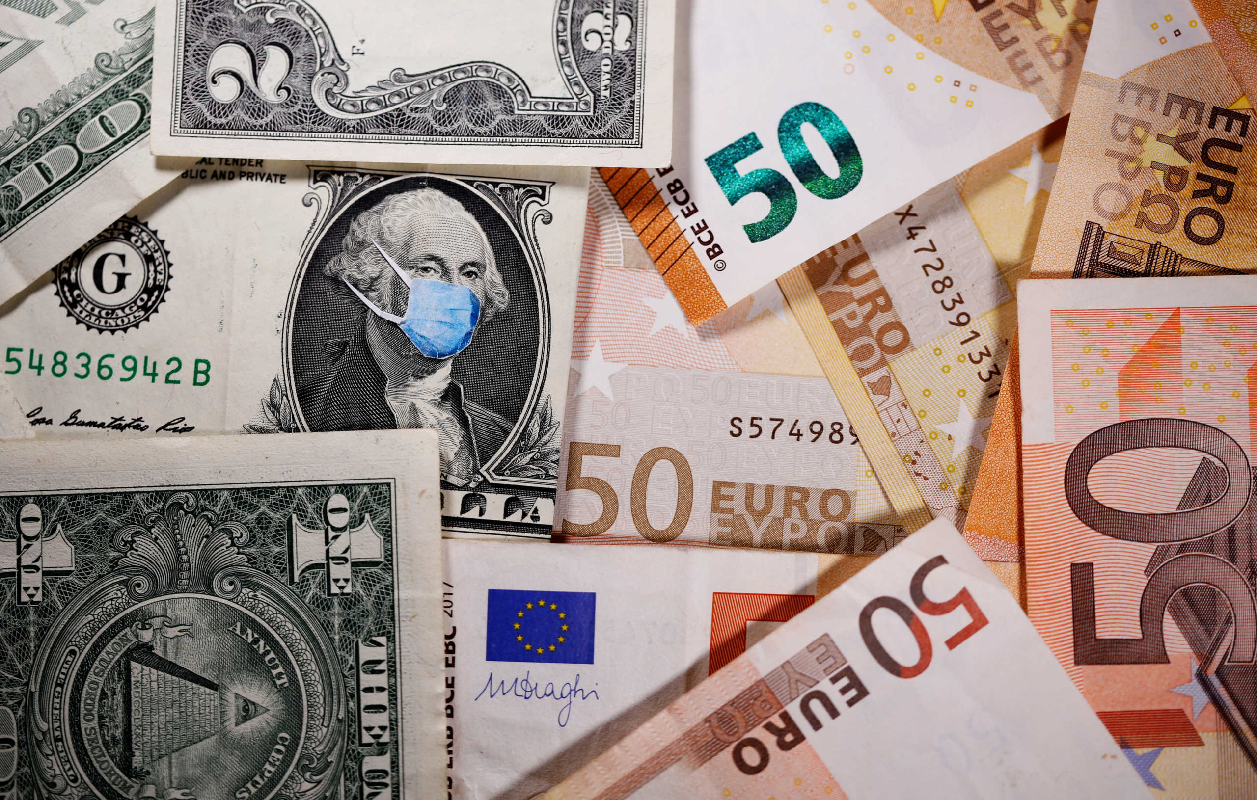 FILE PHOTO: George Washington is seen with printed medical masks on the one Dollar near Euro banknotes in this illustration  taken, March 31, 2020. REUTERS