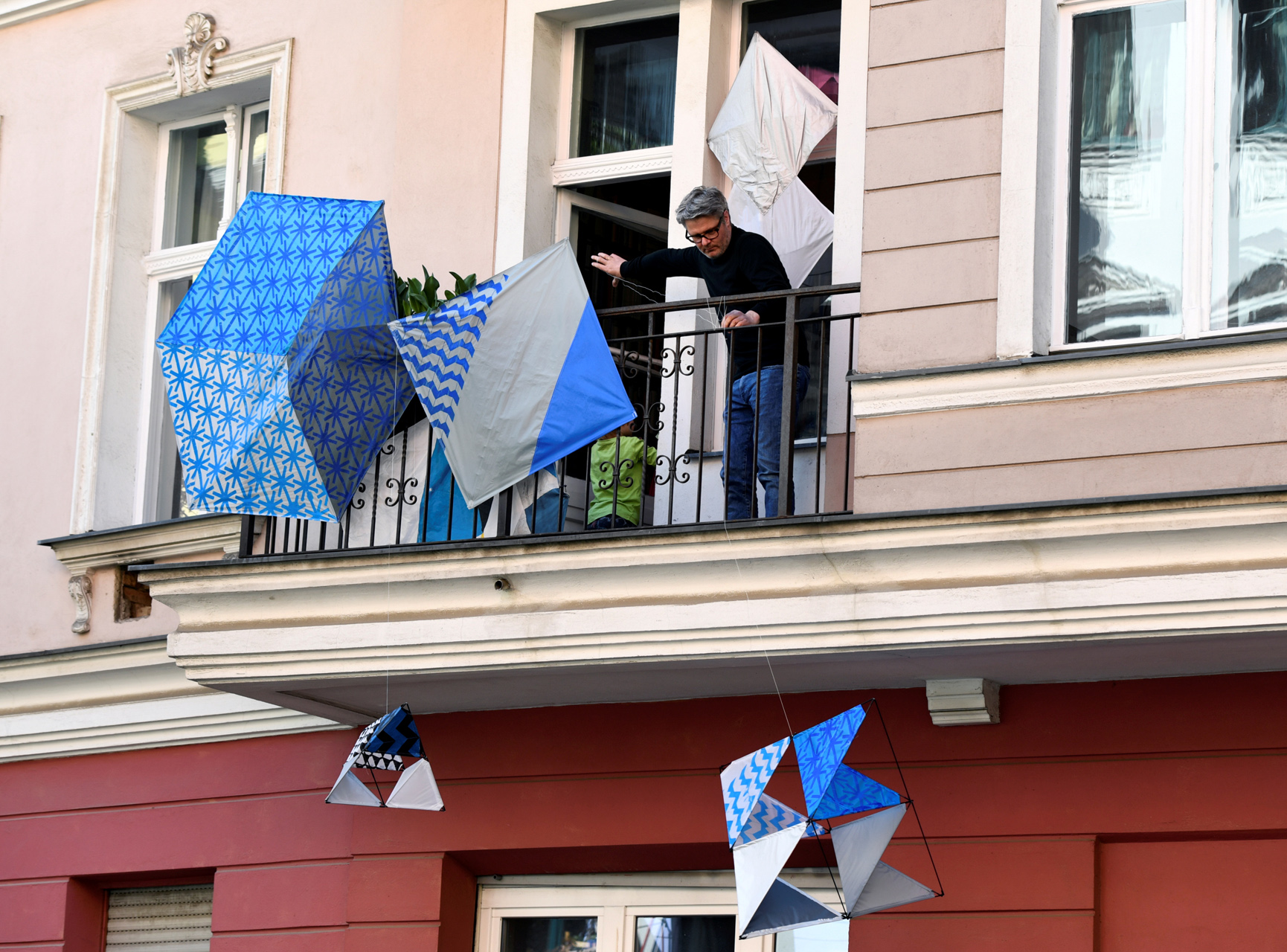 An artist presents an art installation "Die Balkone" (the balconies) on his balcony, as the spread of the coronavirus disease (COVID-19) continues, in Berlin, Germany, April 12, 2020. ONLY TO BE USED RELATED TO STORIES ABOUT "DIE BALKONE". REUTERS