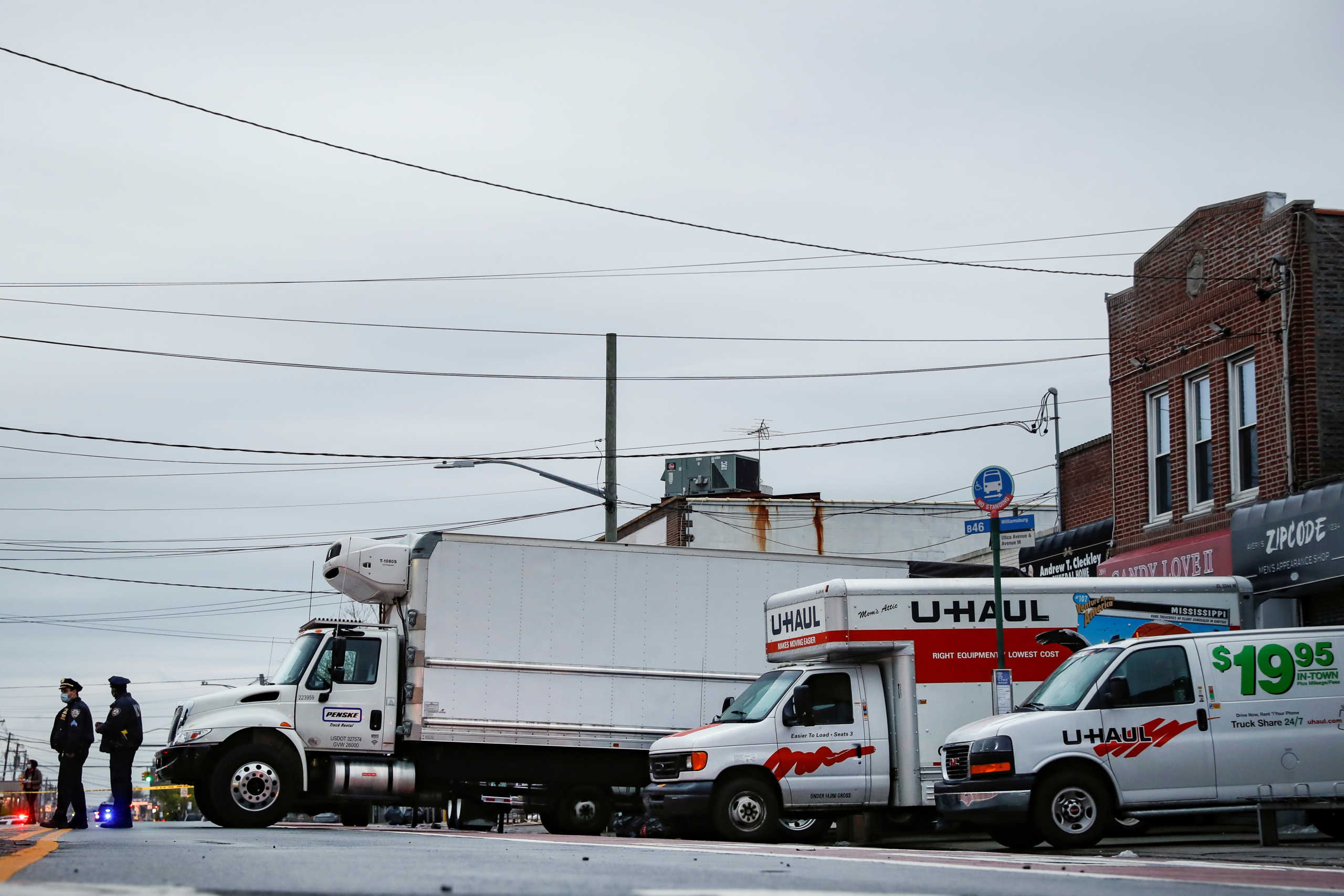 New York City Police Department (NYPD) officers secure trucks full of bodies of deceased people, during the outbreak of coronavirus disease (COVID-19) at the Andrew Cleckley Funeral Home in the Brooklyn borough of New York City, New York, U.S., April 29, 2020. REUTERS