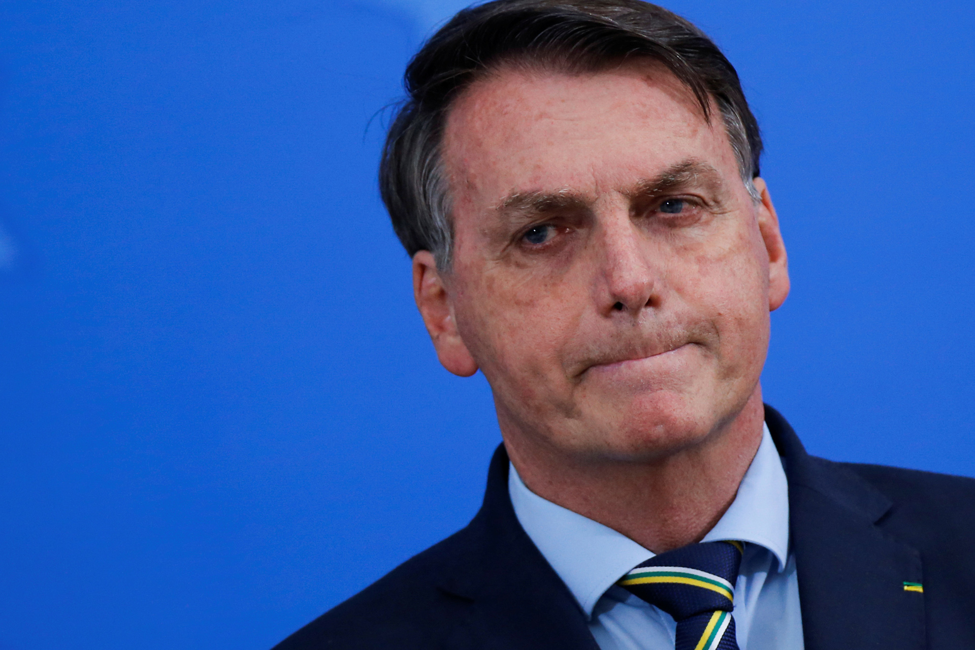Brazil's President Jair Bolsonaro reacts during a media statement to announces the new Minister of Health, Nelson Teich, amid the coronavirus disease (COVID-19) outbreak, in Brasilia, Brazil, April 16, 2020. REUTERS