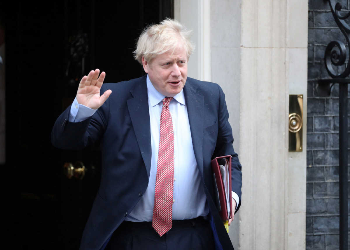 FILE PHOTO: Britain's Prime Minister Boris Johnson waves as he leaves Downing Street, as the spread of coronavirus disease (COVID-19) continues. London, Britain, March 25, 2020. REUTERS