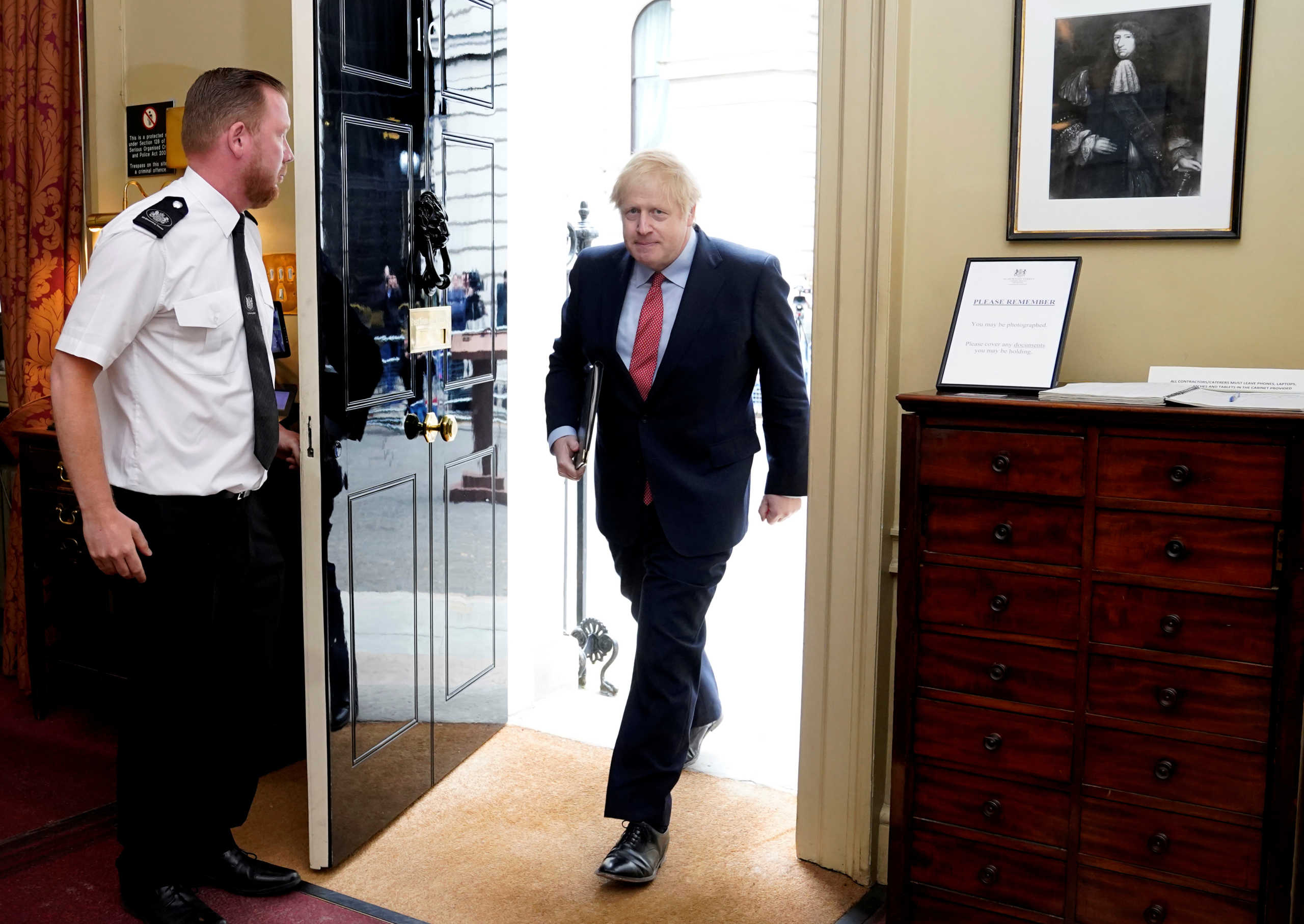 Britain's Prime Minister Boris Johnson walks through the door as he returns to work at 10 Downing Street after recovering from the coronavirus disease (COVID-19), in London, Britain April 27, 2020. Andrew Parsons