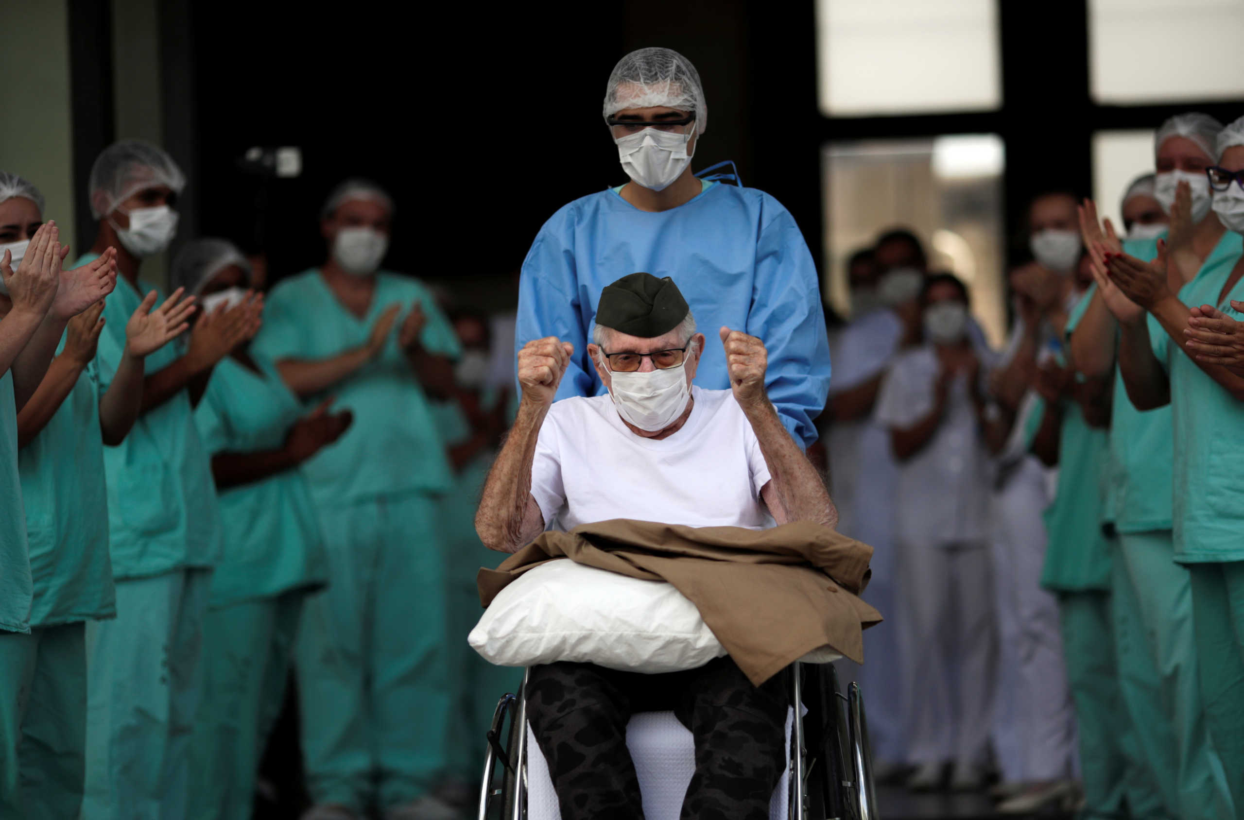 Brazilian 99-year-old former WWII combatant Ermando Armelino Piveta, gestures as leaves the Armed Forces Hospital in Brasilia, after being treated for the novel coronavirus (COVID-19) and discharged, amid the coronavirus disease (COVID-19) outbreak, in Brasilia, Brazil, April 14, 2020. REUTERS