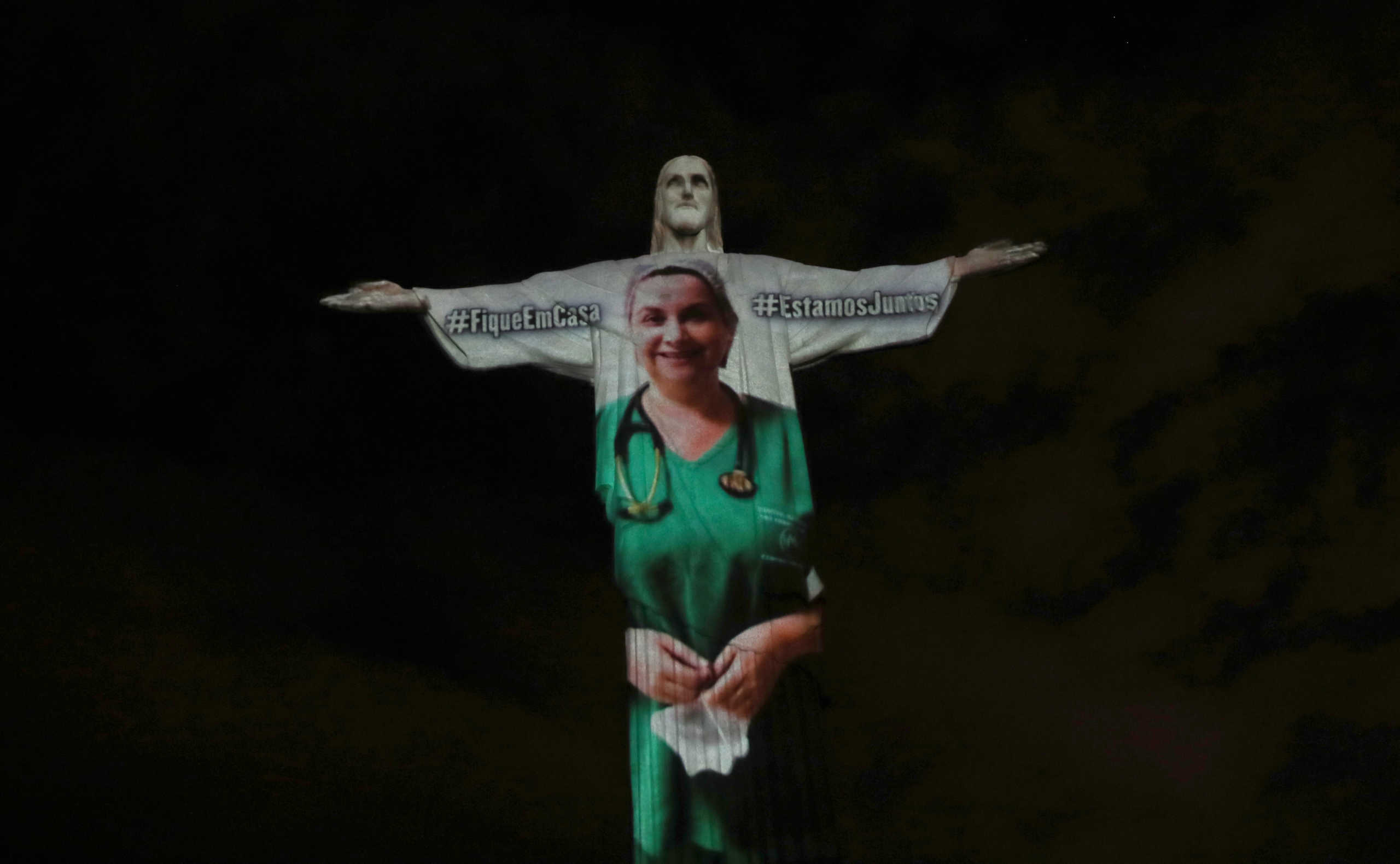 The statue of Christ the Redeemer is lit up with the image of a medical worker during an Easter Sunday event, amid the coronavirus disease (COVID-19) outbreak, in Rio de Janeiro, Brazil April 12, 2020. REUTERS