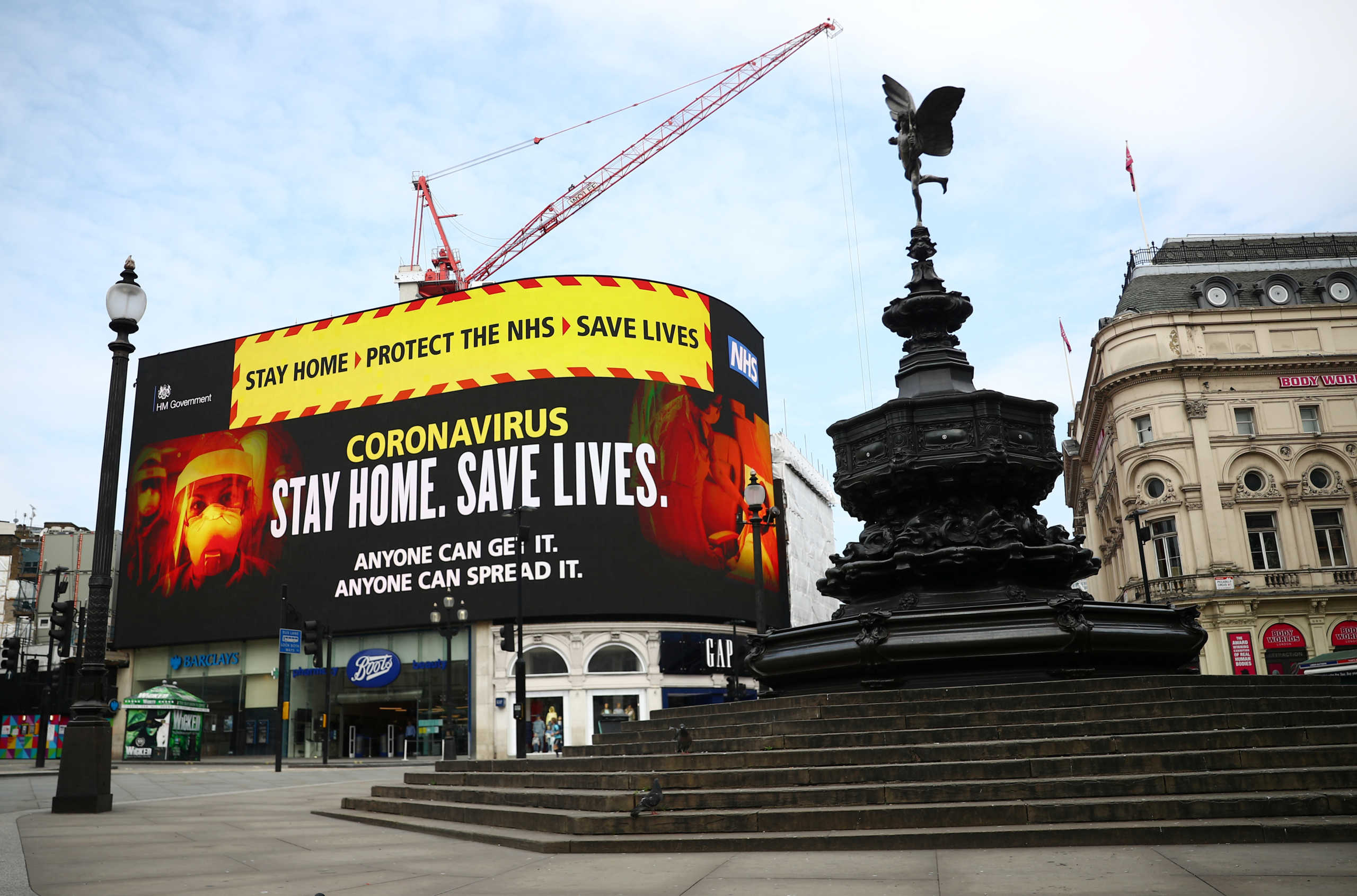 A UK government public health campaign is displayed in Piccadilly Circus, as the spread of the coronavirus disease (COVID-19) continues, London, Britain, April 8, 2020. REUTERS
