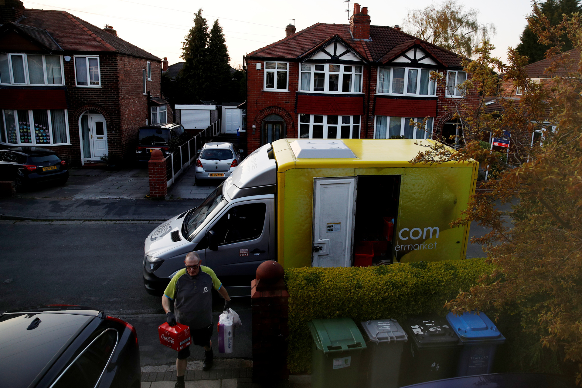 A Ocado van and delivery man deliver to a house in Manchester, as the spread of the coronavirus disease (COVID-19) continues, Manchester, Britain, April 8, 2020. REUTERS