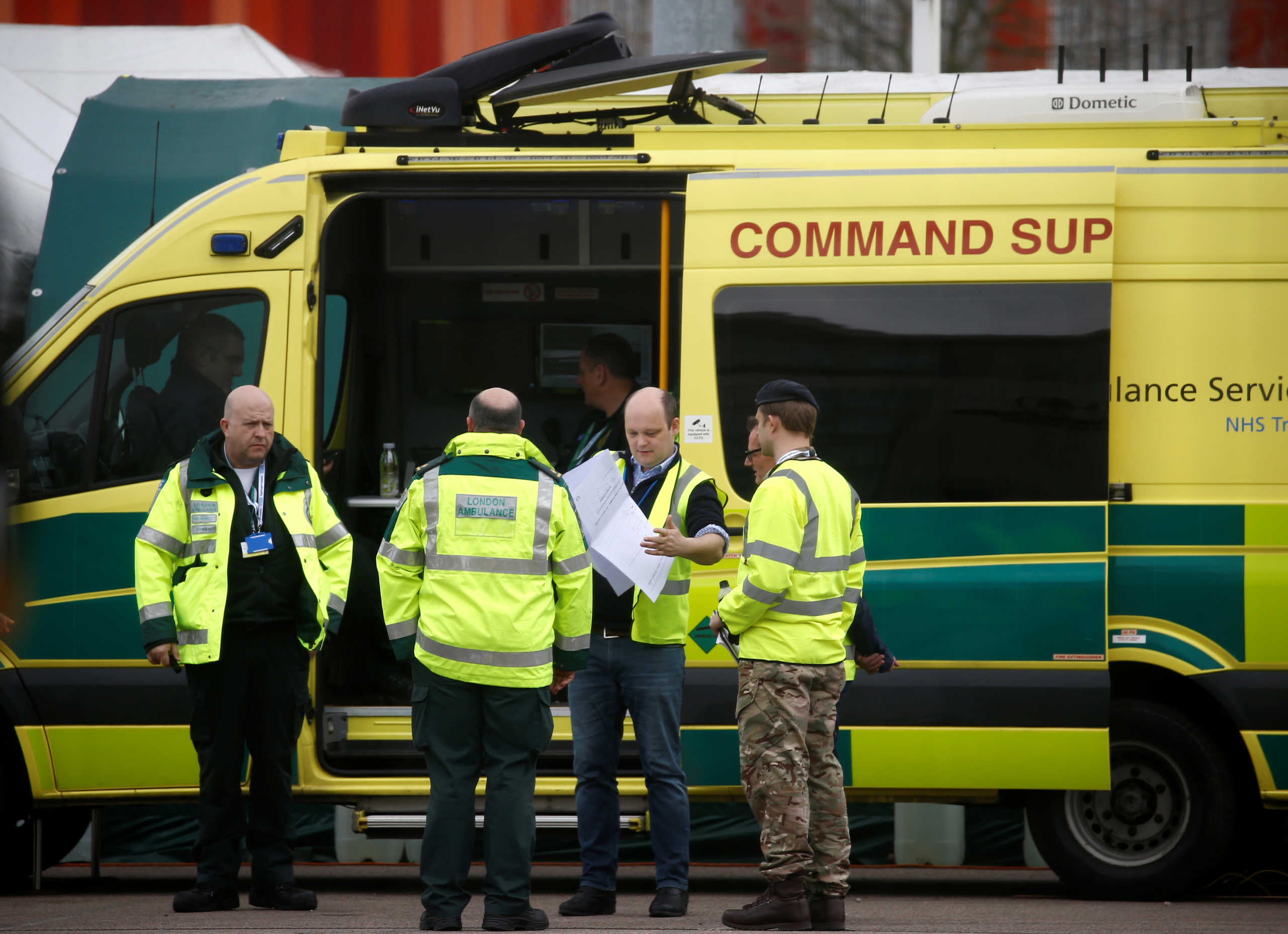 Paramedics and military personnel are seen outside the Excel Centre, London while it is being prepared to become the NHS Nightingale Hospital, as the spread of the coronavirus disease (COVID-19) continues, London, Britain, April 1, 2020. REUTERS
