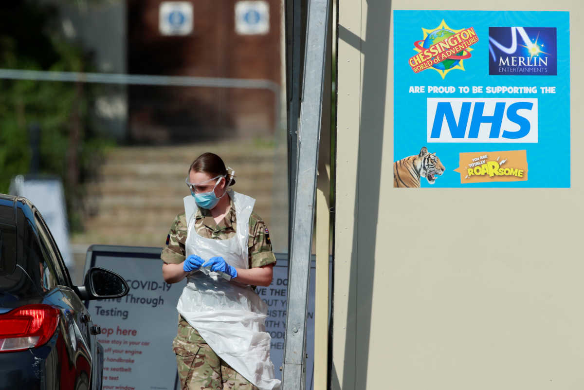Military personnel are seen testing people at a coronavirus test centre in the car park of Chessington World of Adventures as the spread of the coronavirus disease (COVID-19) continues, Chessington, Britain, April 15, 2020. REUTERS