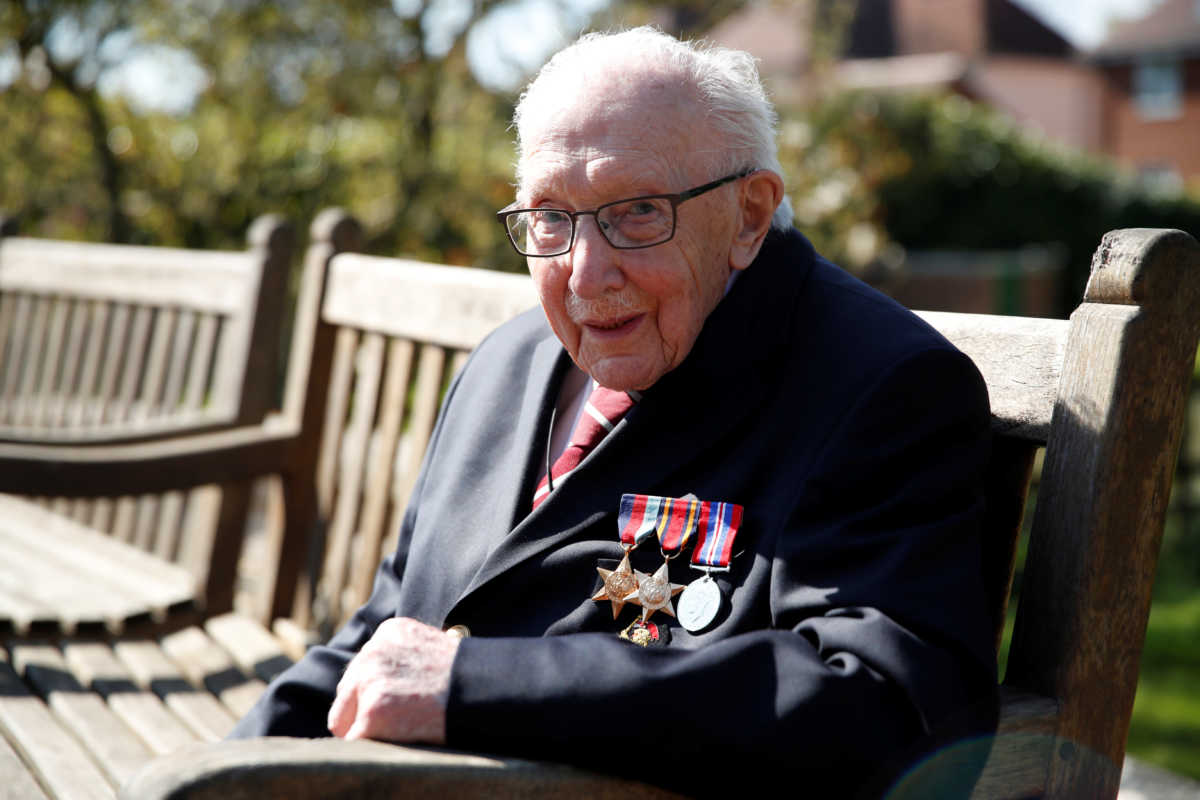 Retired British Army Captain Tom Moore, 99, poses after he continued to raise money for health workers, by attempting to walk the length of his garden one hundred times before his 100th birthday this month as the spread of coronavirus disease (COVID-19) continues, Marston Moretaine, Britain, April 15, 2020. REUTERS
