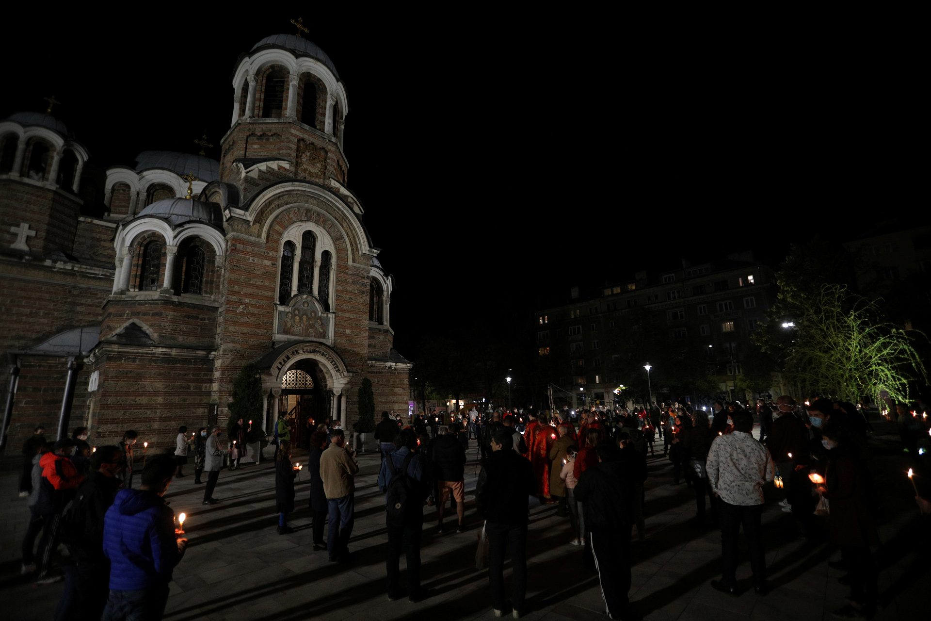 People attend Orthodox Easter service outside Sveti Sedmochislenitsi (Seven Saints) church in Sofia, Bulgaria, April 19, 2020. REUTERS