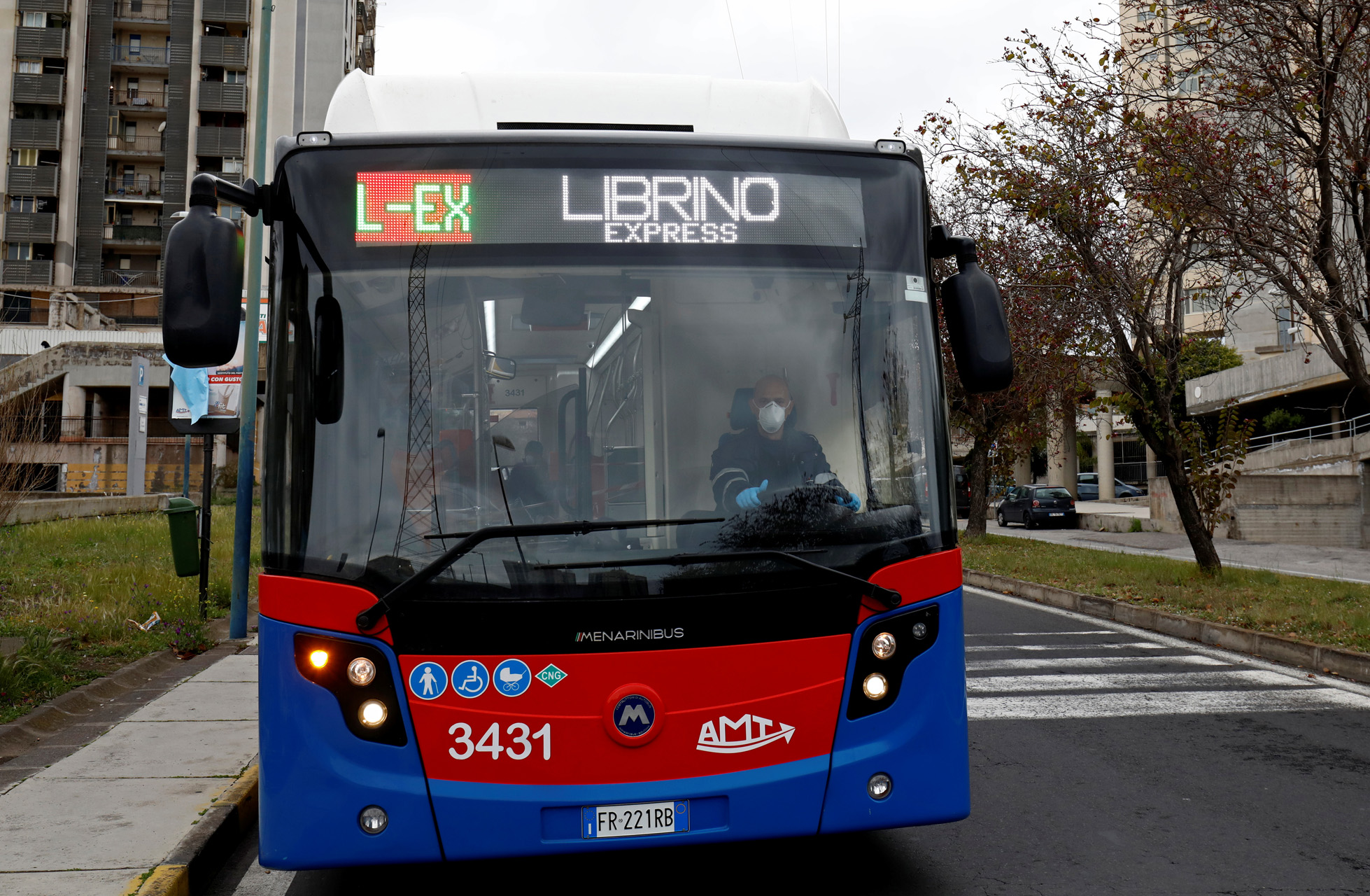 A bus driver wears a protective face mask and gloves, following the coronavirus disease (COVID-19) outbreak, in Catania, Italy April 2, 2020. REUTERS