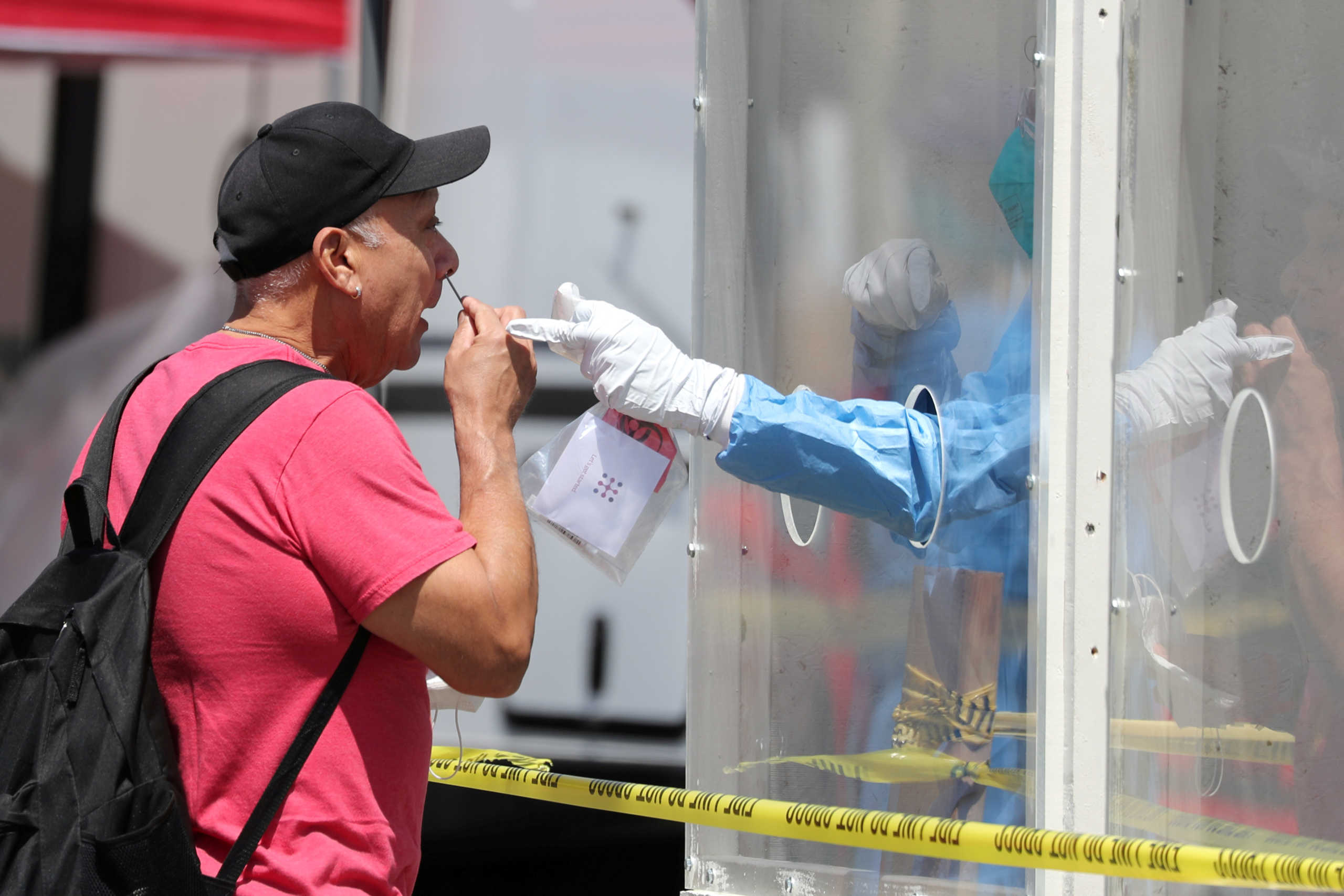 A man is tested for coronavirus disease (COVID-19) at a Los Angeles fire department testing station for the homeless on Skid Row, in Los Angeles, California, U.S., April 21, 2020.  REUTERS