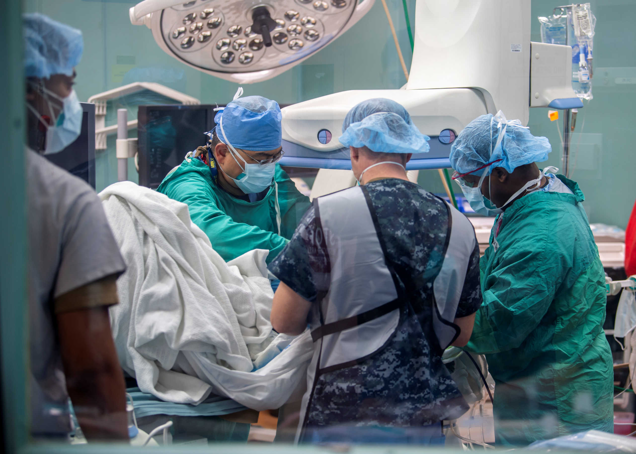 U.S. Navy sailors prepare a patient for an ultrasound in the radiology suite aboard the hospital ship USNS Mercy, serving as a referral hospital for non-coronavirus disease (COVID-19) patients currently admitted to shore-based hospitals, in Los Angeles, California, U.S. April 11, 2020. Picture taken April 11, 2020.  U.S. Navy