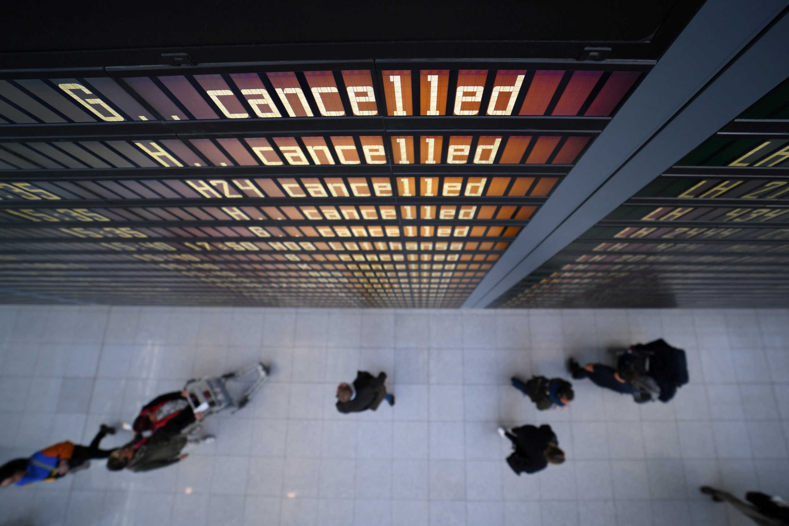 FILE PHOTO: A display board shows most flights as cancelled at the airport in Munich, Germany, February 10, 2020. REUTERS