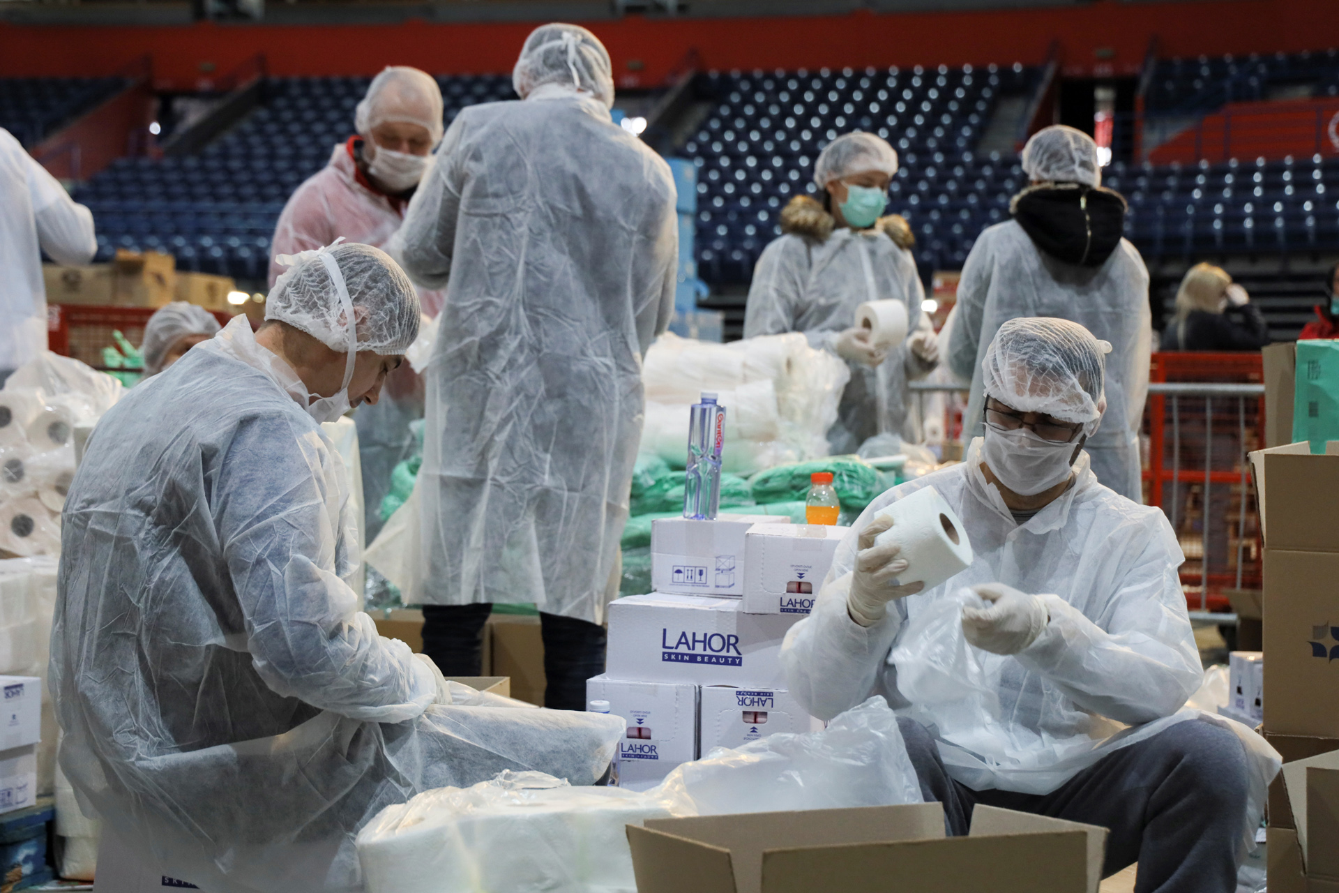 Volunteers help pack boxes of donated aid for elderly people who are banned from leaving their homes because of the coronavirus disease (COVID-19) epidemic in Belgrade, Serbia, March 26, 2020. REUTERS