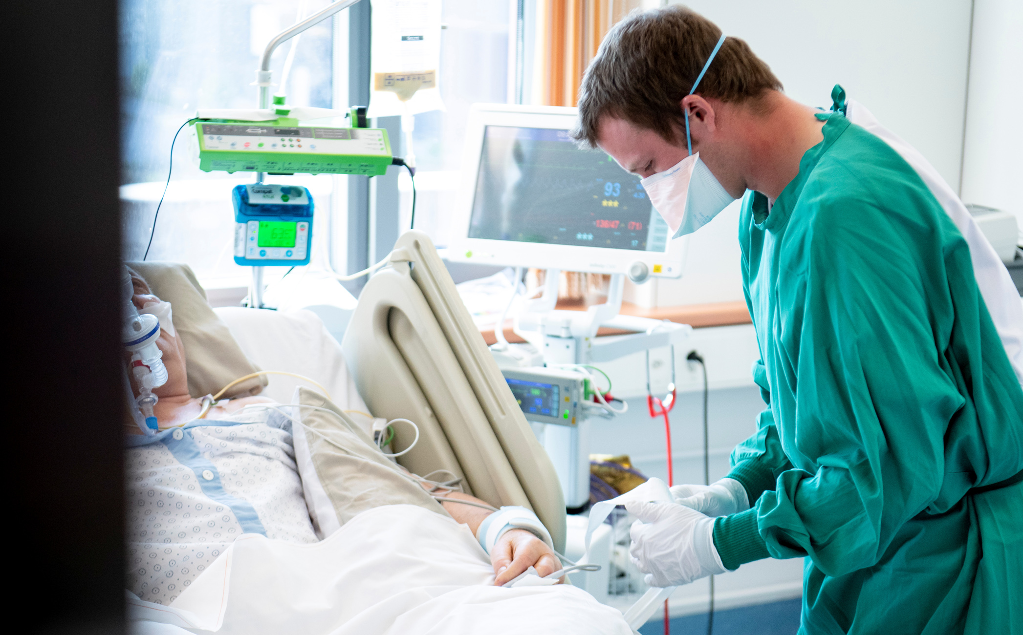 Swiss army soldier Julien treats a patient in the intensive care unit (ICU) of a hospital during the  coronavirus disease (COVID-19) outbreak in Payerne, Switzerland, April 6, 2020.  Laurent Gillieron
